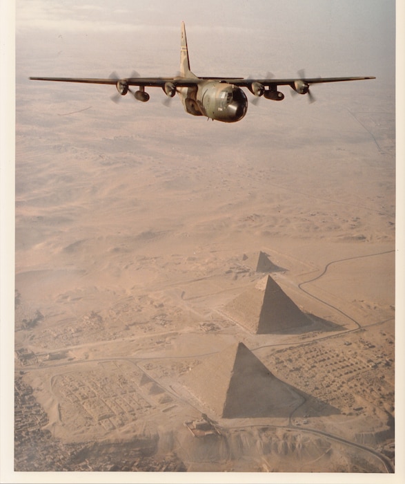 A C-130 of the 130th Tactical Airlift Group, West Virginia Air National Guard, flies over the Pyramids of Giza, Egypt, 1981.