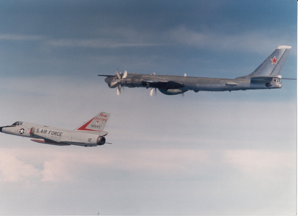 An F-106A Delta Dart of the 177th Fighter Interceptor Group, New Jersey Air National Guard, escorts a Soviet Tu-95RT (“Bear”) maritime surveillance aircraft off the U.S. East Coast, around 1980.