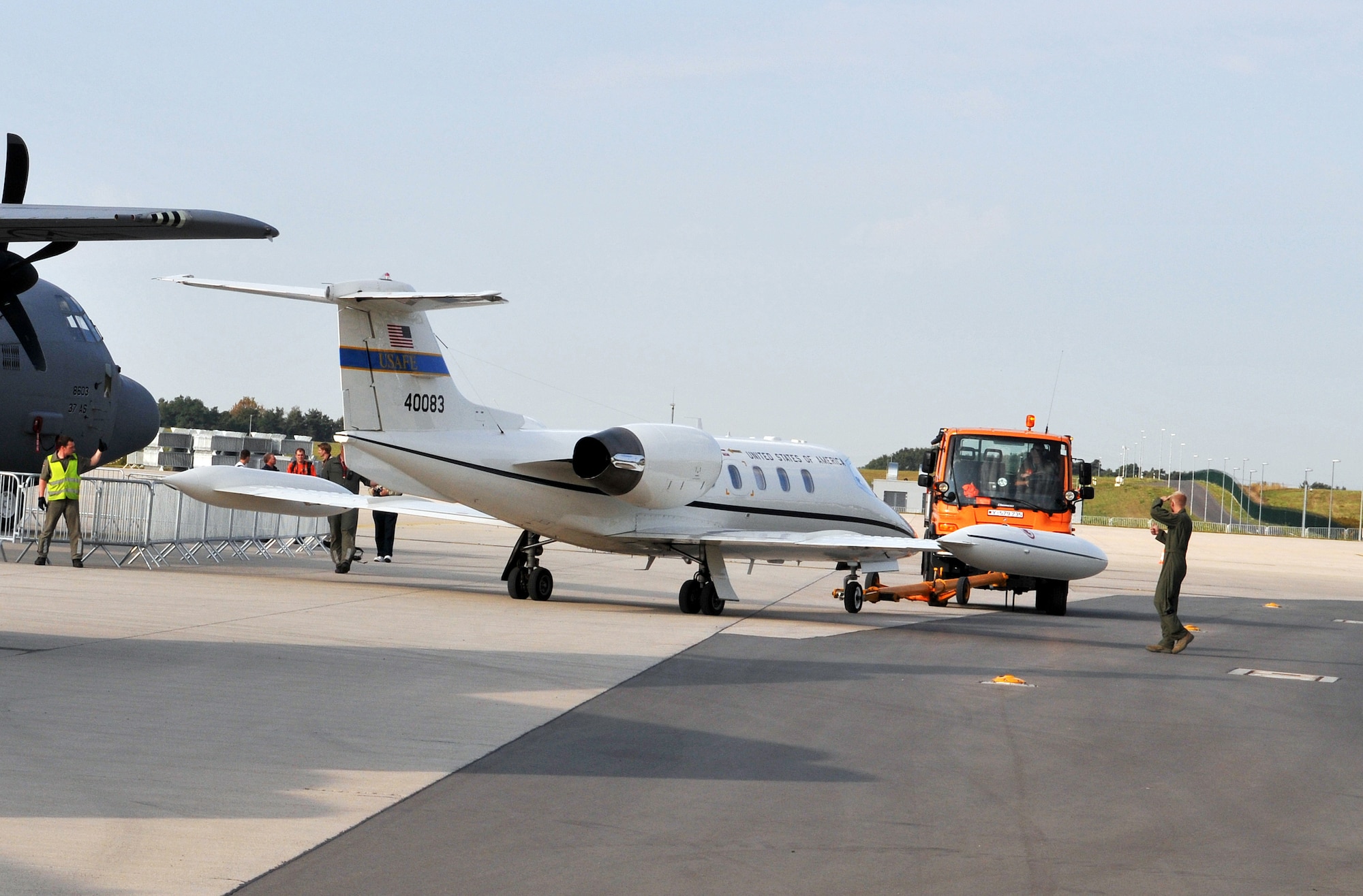 BERLIN - Members of the German air force move a USAFE C-21 aircraft while setting up the ILA 2012 Berlin Air Show here Sept. 10. More than 300,000 visitors from across the world are expected to visit ILA 2012 Sept. 11-16. ILA 2012 is an international event hosted by Germany. More than 50 U.S. military personnel from bases in Europe and the United States were on site to showcase the various U.S. military aircraft and equipment on display. The U.S. aircraft featured at ILA 2012 were the UH-60 Black Hawk, UH-72A Lakota, F-16C Fighting Falcon, C-17 Globemaster III, and C-130 Hercules. (U.S. Air Force photo/Staff Sgt. Tabitha Lee)