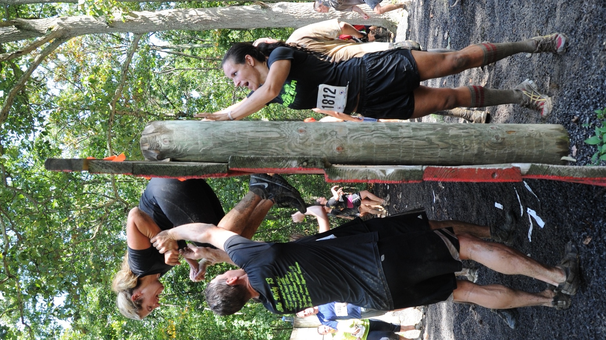 Participants help each other climb over a wall Sept. 8 during the “Be All You Can Be” obstacle course at the Joint Base McGuire-Dix-Lakehurst ‘Beast of the East’ Mud Run. The event was much more than a run for the 2,500 runners who raced through JB MDL and braved 23 obstacles. (U.S. Air Force photo by 2nd Lt. Alexis McGee/Released)
