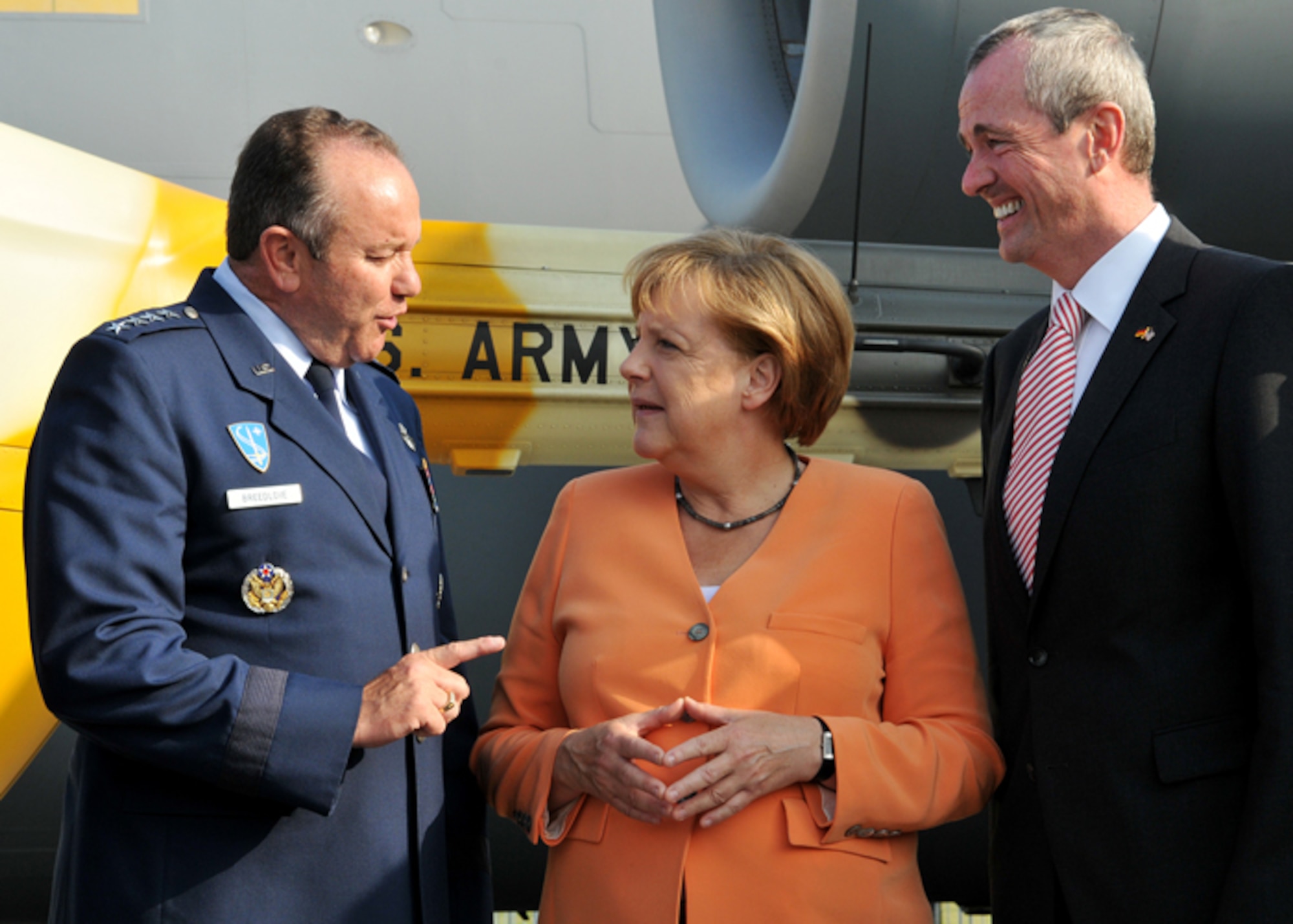 BERLIN - Chancellor Angela Merkel of Germany, greets Philip Murphy, U.S. ambassador to Germany, and Gen. Philip Breedlove, U.S. Air Forces in Europe and U.S. Air Forces Africa commander, during a tour of the U.S. military aircraft “corral” at the Berlin Air Show, commonly known as ILA 2012, here Sept 11. ILA 2012 is an international event hosted by Germany. More than 50 U.S. military personnel from bases in Europe and the U.S. show cased various U.S. military aircraft and equipment on display. The U.S. aircraft featured at ILA 2012 are the UH-60 Black Hawk, UH-72A Lakota, F-16C Fighting Falcon, C-17 Globemaster III, and C-130 Hercules.