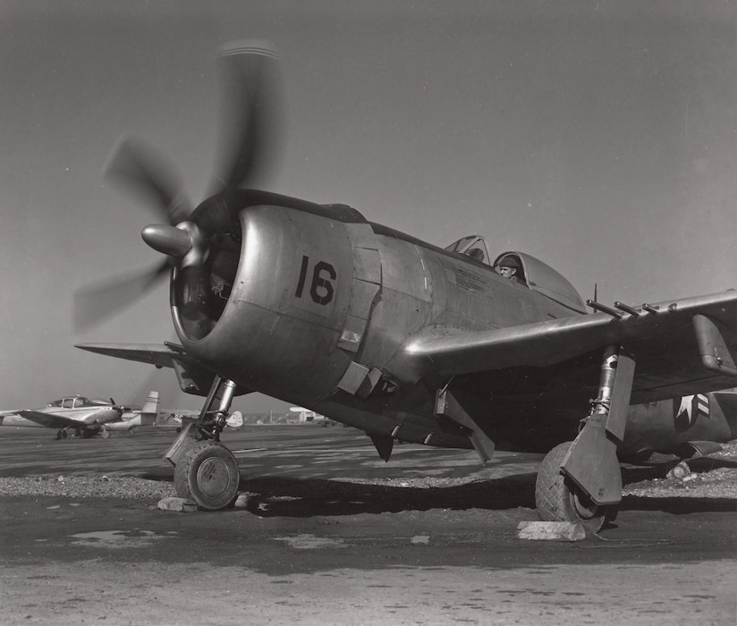 A mechanic of the 104th Fighter Squadron, Maryland National Guard tests the engine of a Republic F-47 Thunderbolt. Note the civilian light aircraft in the background.