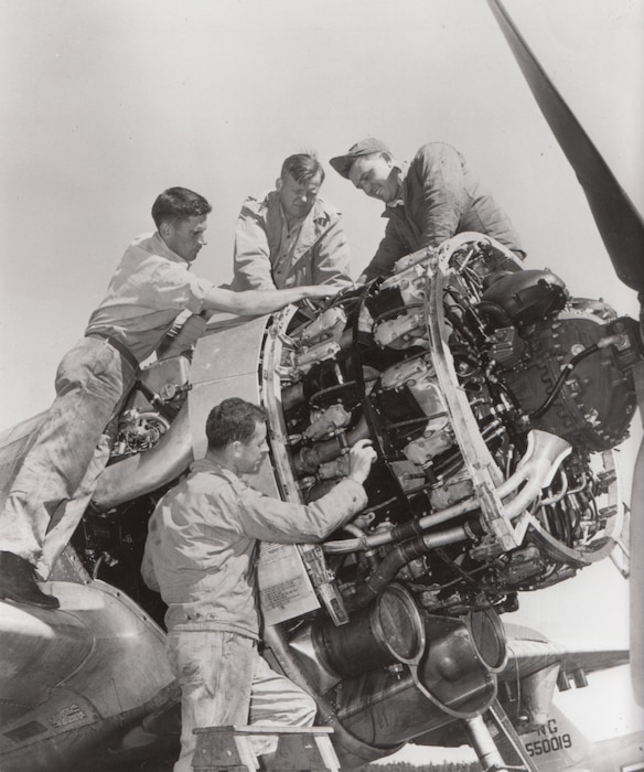 Mechanics of the 118th Fighter Squadron, Connecticut Air National Guard, do engine work on an F-47 at Brainard Field, Hartford Connecticut.