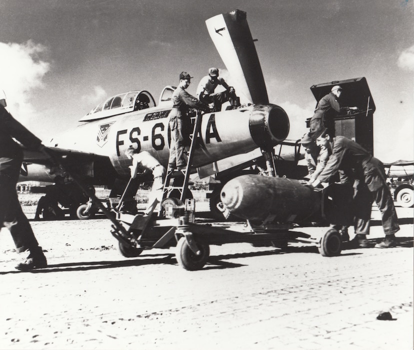 Ground crewmen prepare an F-84 of the 159th Fighter Squadron, Florida Air National Guard, for a combat mission. The unit was deployed to a forward airbase in Korea at the time.