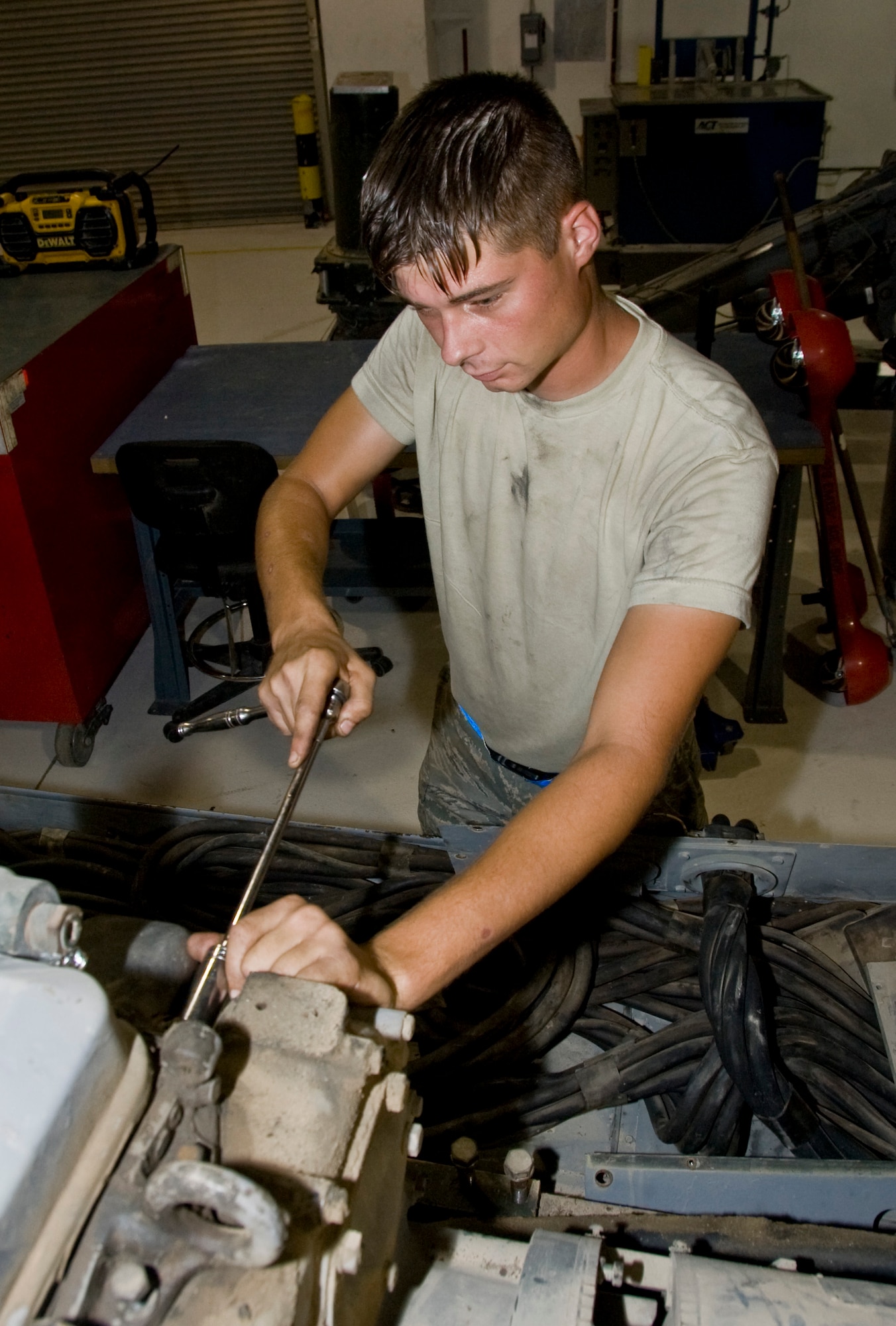 Senior Airman Travis Jordan, 379th Expeditionary Maintenance Squadron Aerospace Ground Equipment Flight journeyman, completes the removal of an exhaust manifold on a -86 diesel generator Aug. 29, 2012. The 379 EMXS AGE Flight is the largest AGE Flight in the area of responsibility. They support seven different airframes and more than 675 pieces of support equipment. (U.S. Air Force photo/Senior Airman Bryan Swink)