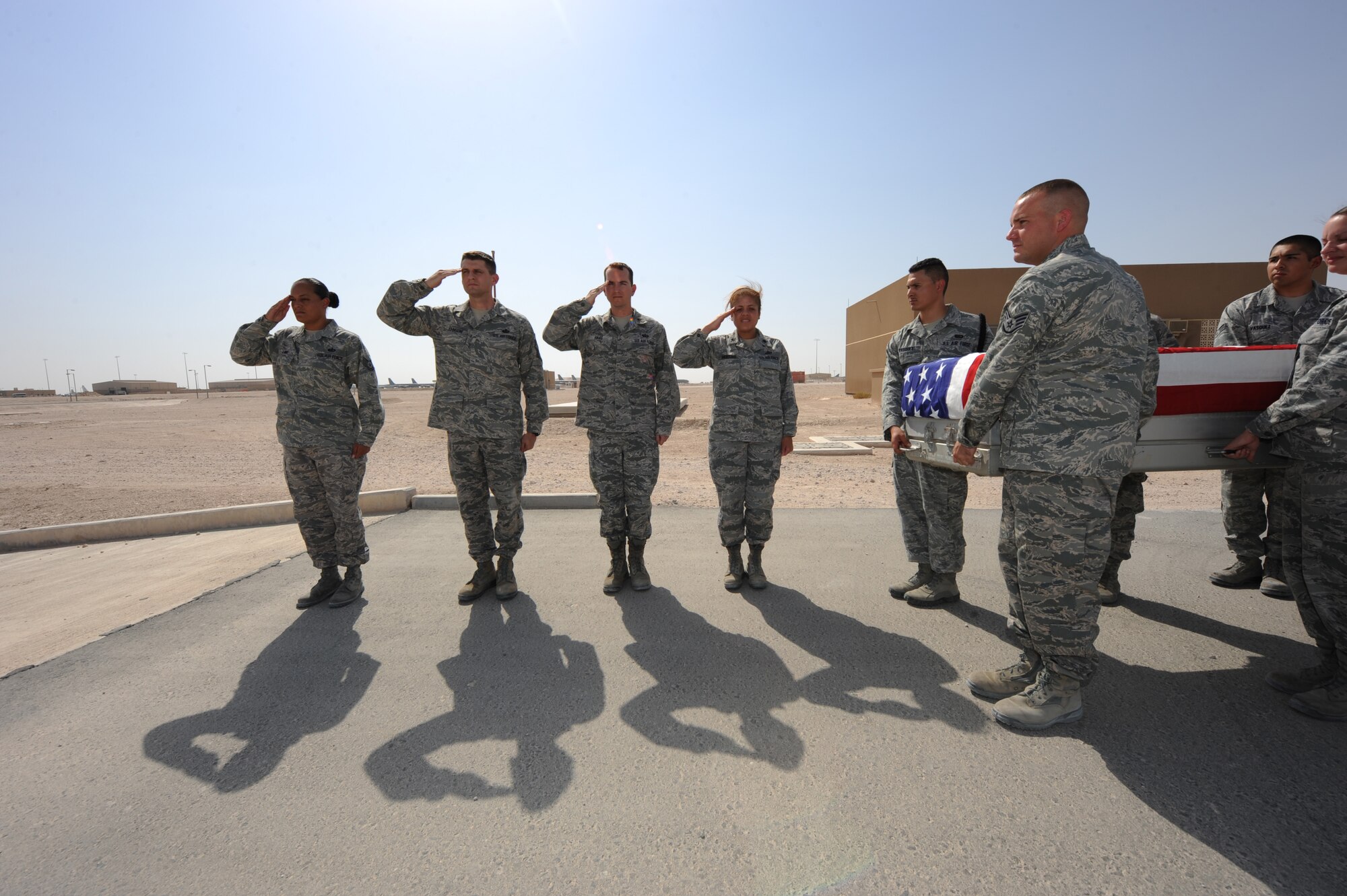 379th Expeditionary Force Support Squadron volunteers practice executing a dignified transfer as part of the Fallen Warrior Program Sept. 3, 2012. The team repeatedly practices the transfer to ensure a flawless execution of any service member as they pass through here on their way home. The Fallen Warrior program is the onward movement of a service member who was killed in the line of duty. (U.S. Air Force photo/Staff Sgt. Sheila deVera)