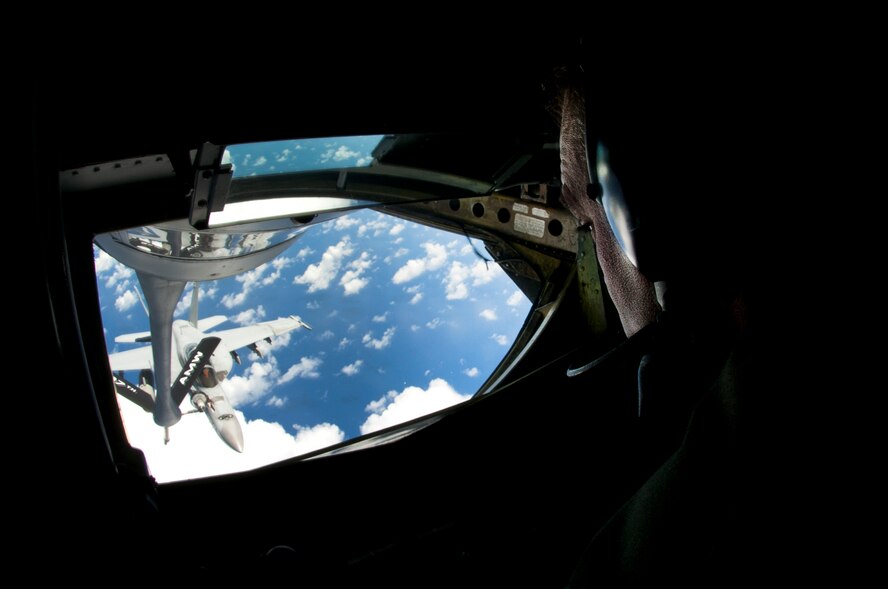 Andersen AFB, Guam --Master Sgt. Jim Doyle, 157th Air Refueling Wing boom operator, guides a drogue to refuel a U.S. Marine Corps F/A-18 Hornet from the Marine Aircraft Group 12 at Marine Corps Air Station Iwakuni, Japan during Valiant Shield 2012 over the Pacific Ocean Sept. 14, 2012. VS12 is a U.S.-only exercise with a focus on integration of joint training among U.S. forces in relation to current operational plans. This training enables real-world proficiency in sustaining joint forces through detecting, locating, tracking and engaging units at sea, in the air, on land and cyberspace in response to a range of mission areas.  (U.S. Air Force photo by Staff Sgt. Alexandre Montes/RELEASED)