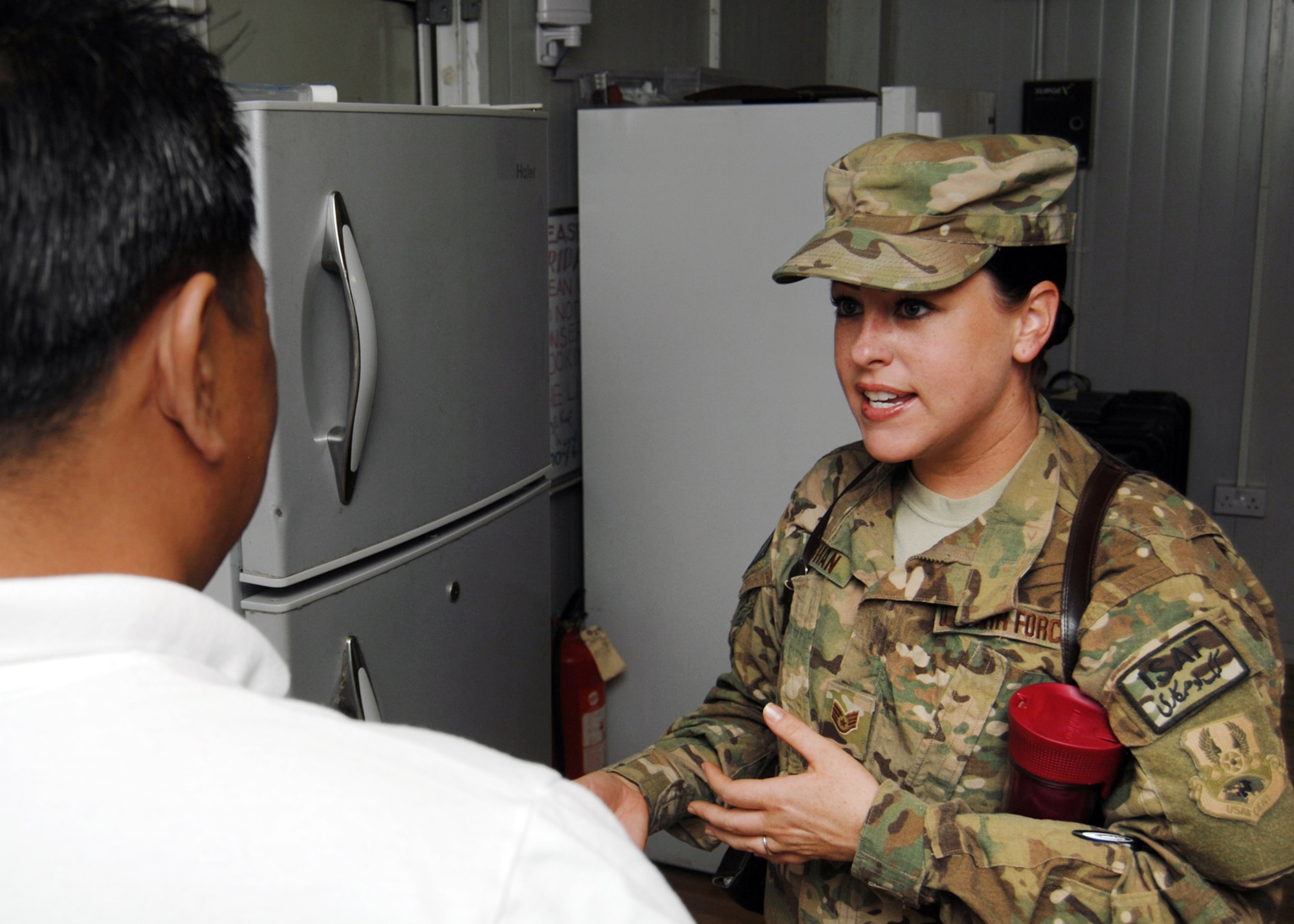 U.S. Air Force Staff Sgt. Jennifer Vaughan, 451st Air Expeditionary Wing public health technician speaks with the manager of a camp that was inspected recently. She offers directions and advice to the managers to bring their kitchen and dining facilities up to standards. (U.S. Air Force photo/Master Sgt. Russell Martin)