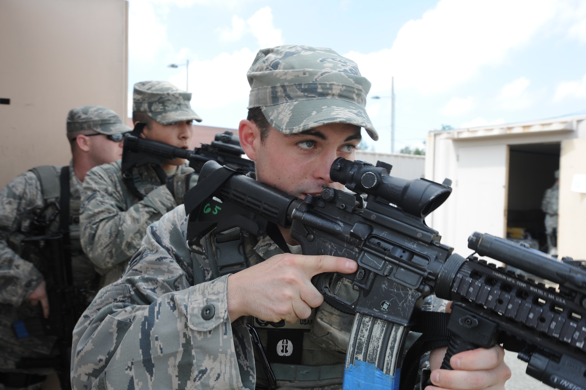 Airman 1st Class Michael Ruff, 51st Security Forces Squadron Quick Reaction Team fire team leader, prepares to secure a building during a training scenario at Osan Air Base, Republic of Korea, Sept. 8, 2012. The Airmen who make up the QRT must undergo eight weeks of training to qualify. (U.S. Air Force photo/Airman 1st Class Alexis Siekert)
