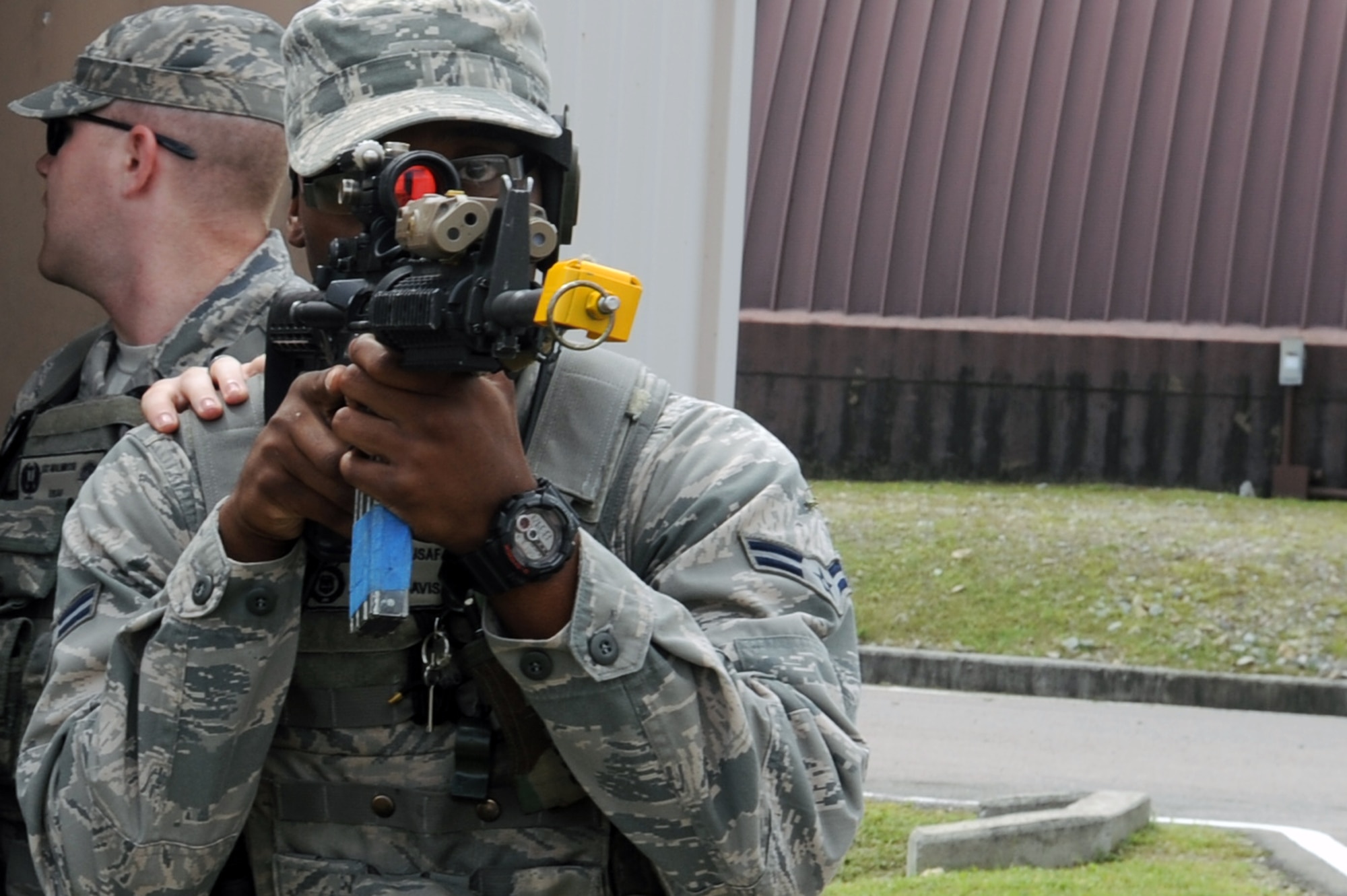 Airman 1st Class Adrian Davis, 51st Security Forces Squadron Quick Reaction Team member, prepares to respond to a hostage situation during a training scenario at Osan Air Base, Republic of Korea, Sept. 8, 2012. During the training exercise, the team demonstrated their ability to work together to clear an area of opposing forces. (U.S. Air Force photo/Airman 1st Class Alexis Siekert)