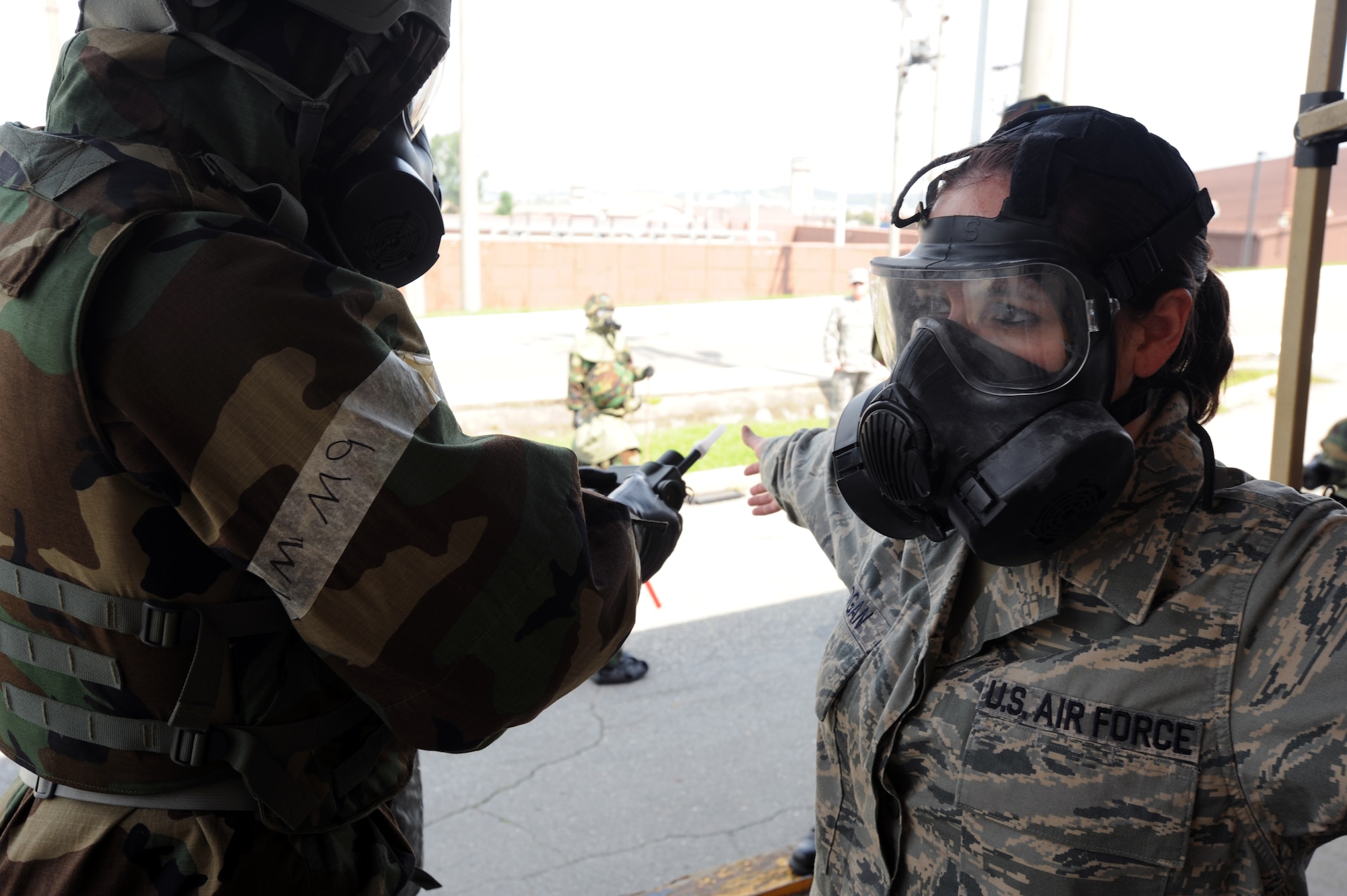 Staff Sgt. Mikel Rogers (right), 51st Civil Engineer Squadron Emergency Management journeyman, monitors Senior Airman Angel Logan, 51st CES Emergency Management journeyman, for contamination during a combined force training exercise at Osan Air Base, Republic of Korea, Sept. 7, 2012. U.S. Air Force and Republic of Korea Air Force members conducted post attack reconnaissance sweeps and decontamination procedures during the exercise. (U.S. Air Force photo/Airman 1st Class Alexis Siekert)