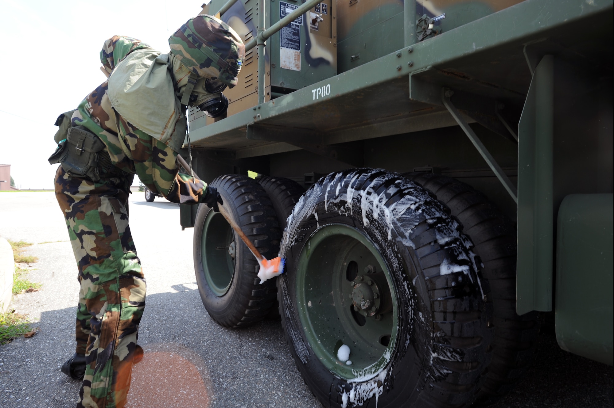 A Republic of Korea Air Force chemical warfare member simulates a vehicle decontamination during a combined force chemical, biological, radiological, nuclear, and high yield attack response exercise at Osan Air Base, Republic of Korea, Sept. 7, 2012. The combined training exercise was designed to have U.S. Air Force and ROKAF members exchange training techniques. (U.S. Air Force photo/Airman 1st Class Alexis Siekert)