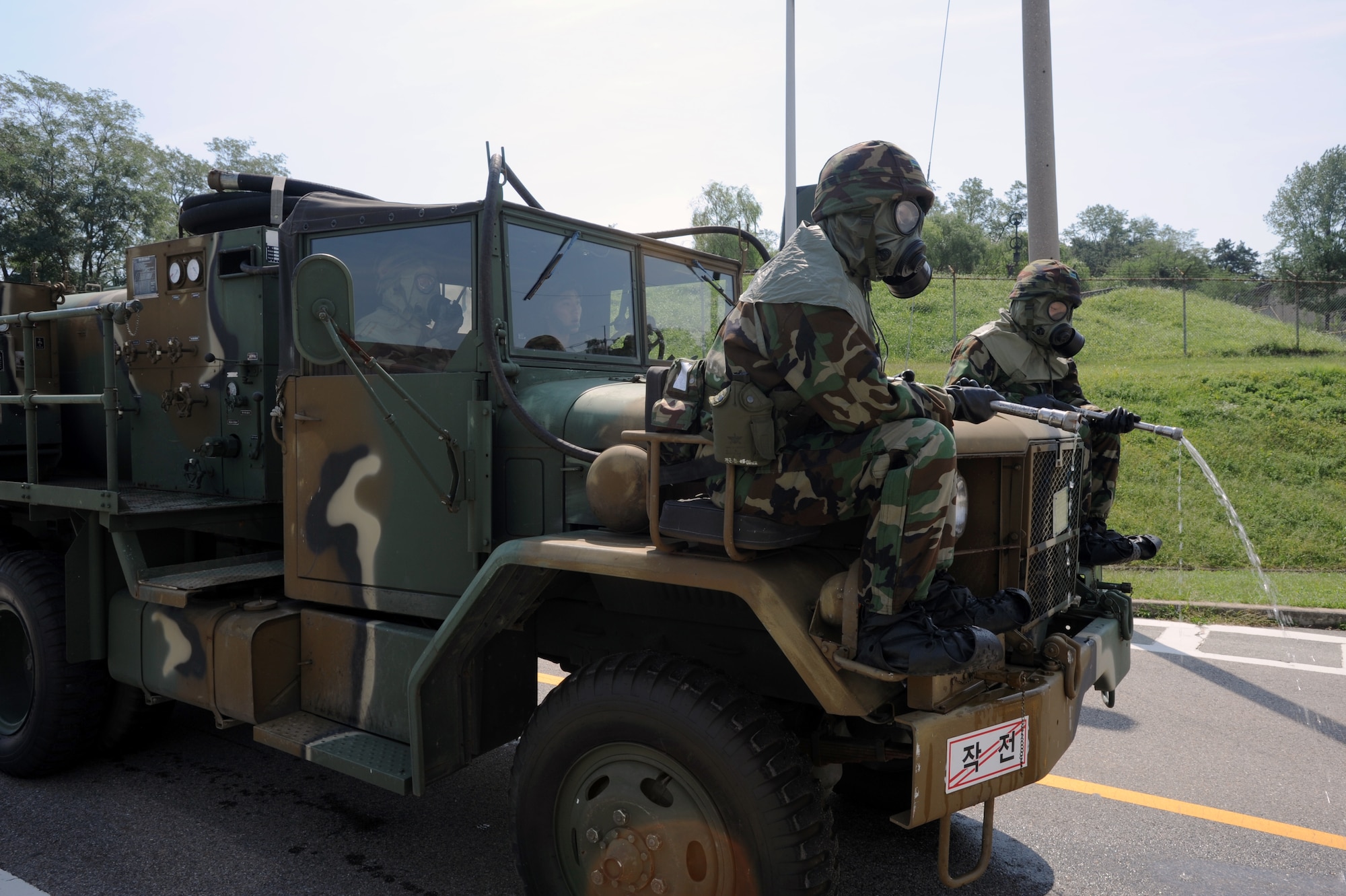 Republic of Korea Air Force chemical warfare members prepare to decontaminate a roadway during a combined force exercise at Osan Air Base, Republic of Korea, Sept. 7, 2012. U.S. Air Force and ROKAF members gained insight into each other’s emergency management procedures during the exercise. (U.S. Air Force photo/Airman 1st Class Alexis Siekert)

