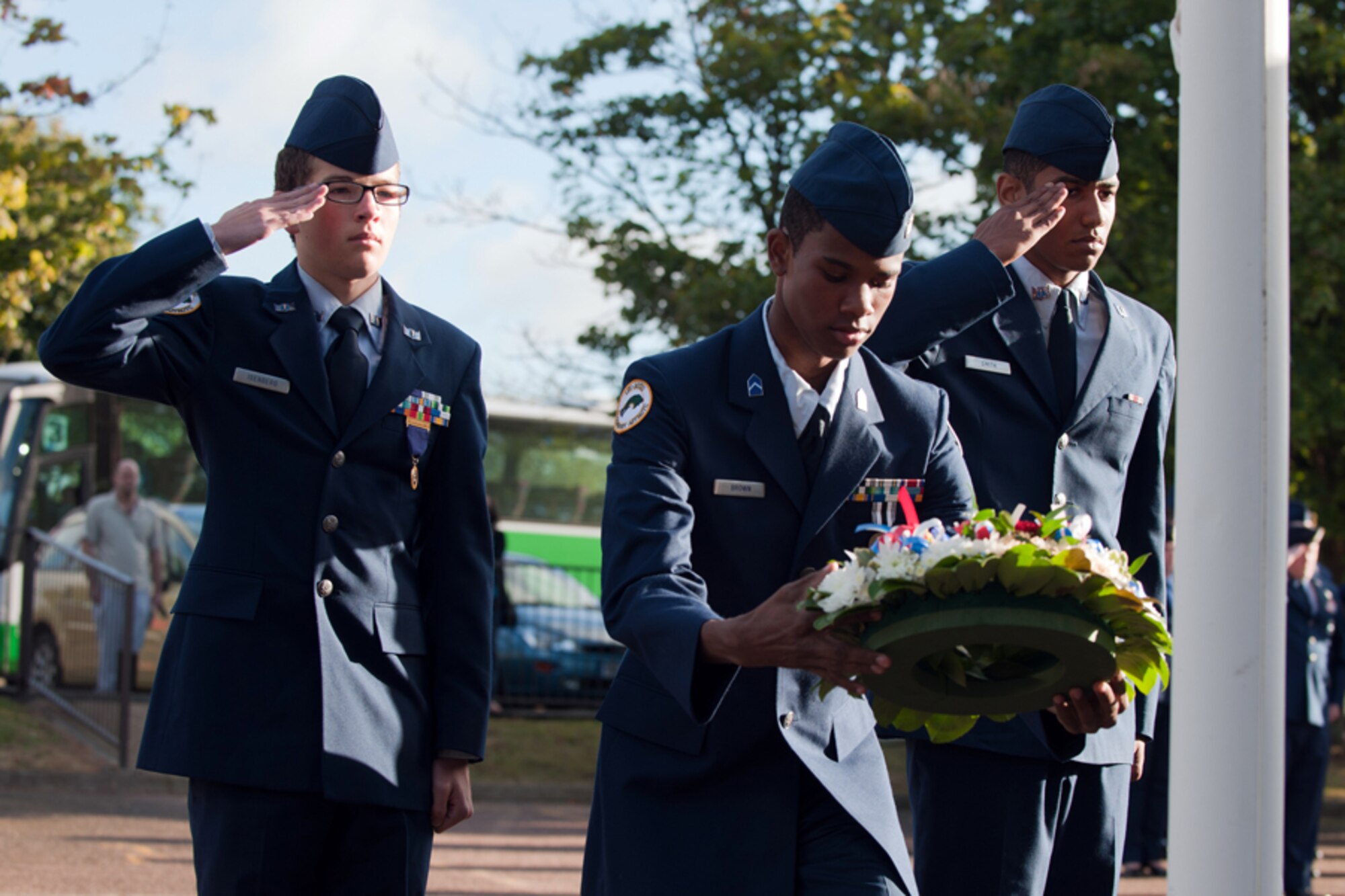 RAF ALCONBURY, United Kingdom – Alconbury High School JROTC cadets salute during the placement of a wreath at the base of the school flagpole in remembrance of 9/11 during a ceremony at the school Sept. 11. This year marked the 11th anniversary of the attacks. (U.S. Air Force photo by Master Sgt. John Barton)