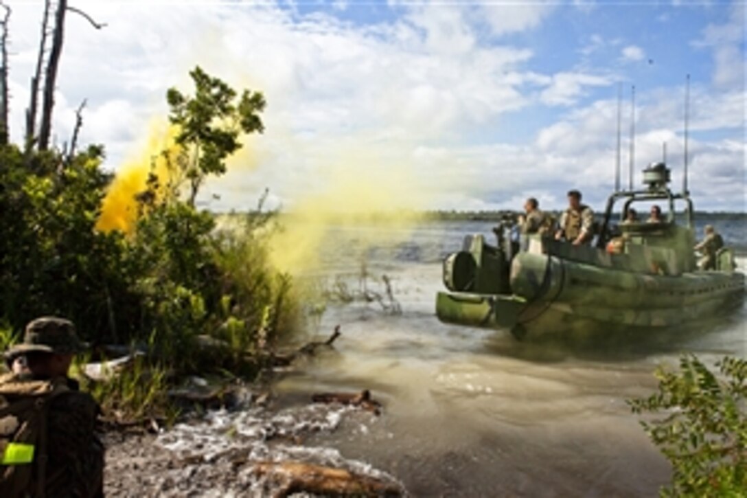 Sailors coast into the shore to extract a squad of Marines as part of a training scenario during UNITAS-Partnership of the Americas 2012 on Camp Blanding, Fla., Sept. 8, 2012. The sailors are assigned to Riverine Squadron 3. UNITAS-Partnership of the Americas is a multi-national exercise that gives participating troops an opportunity to build partnerships while reinforcing essential tactics and techniques.