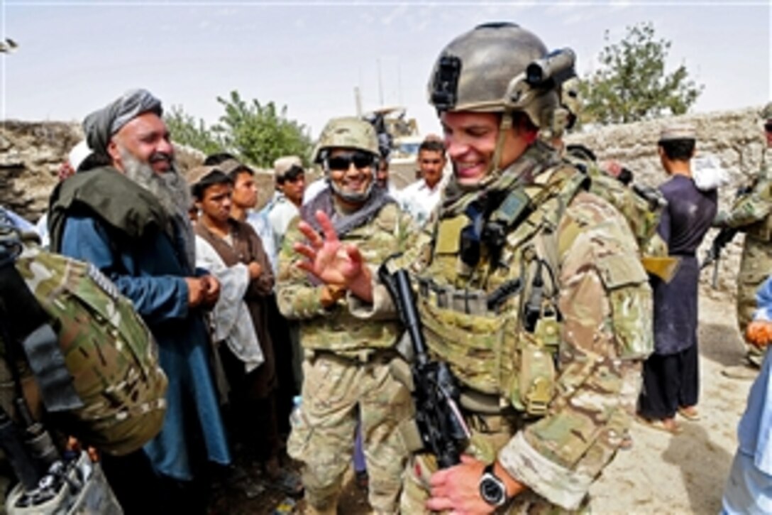 A U.S. service member assigned to Provincial Reconstruction Team Farah shares a laugh with villagers while conducting interviews during a civil affairs mission in Dizak village in Afghanistan's Farah province, Sept. 12, 2012.