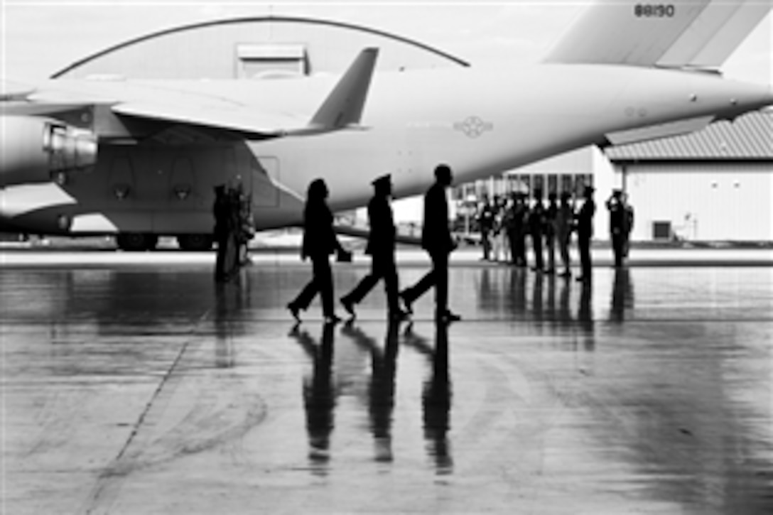 President Barack Obama, followed by Army Chaplain Col. J. Wesley Smith and Secretary of State Hillary Rodham Clinton, walks toward the podium during the transfer of remains ceremony at Joint Base Andrews, Md., Sept. 14, 2012, marking the return to the United States of the remains of the four Americans killed in Benghazi, Libya.  