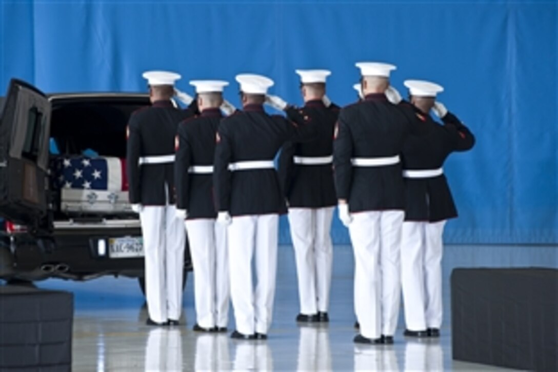 U.S. Marines salute during the dignified transfer ceremony for the U.S. Ambassador to Libya J. Christopher Stevens, Foreign Service officer Sean Smith, and security officers Tyrone S. Woods and Glen A. Doherty on Joint Base Andrews, Md., Sept. 14, 2012. 