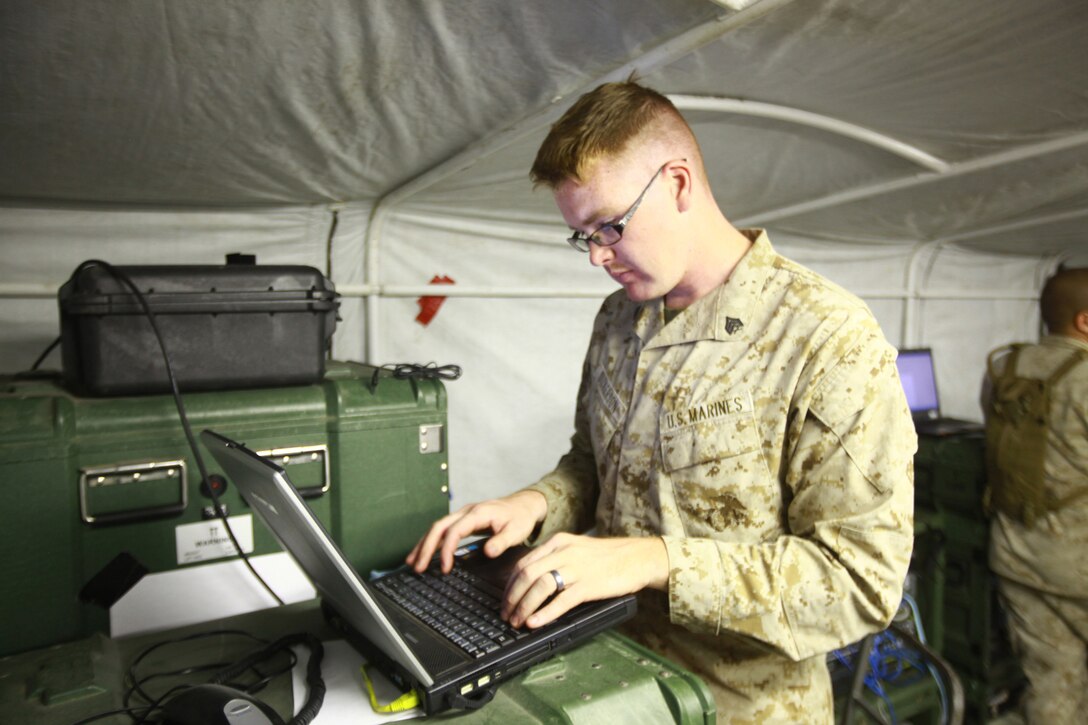 Sgt. John Dickerson, a technical controller for Communications Company, Combat Logistics Regiment 27, works on the communications equipment during a training exercise aboard Camp Lejeune, N.C., Sept. 11, 2012. Dickerson checks the computer to make sure the network is running correctly so mishaps do not occur during the training exercise.