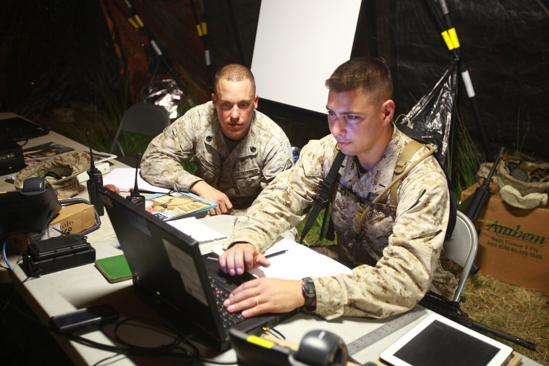 Marines with Communications Company, Combat Logistics Regiment 27, 2nd Marine Logistics Group check a network in Systems Command during a field exercise aboard Camp Lejeune, N.C., Sept. 11, 2012. The Marines constantly monitor the computer to make sure the network is running correctly so mishaps do not occur during the training exercise.  