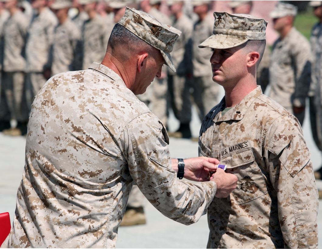 1st Lt. Robert Palumbo, is awarded a Purple Heart Medal August 31 by Brig. Gen. James W. Lukeman, the commanding general of 2nd Marine Division.  Palumbo, a Killingworth, Conn., native, earned the award for his actions in combat on January 10, 2012 while leading his section in support of Operation Enduring Freedom while serving as a team leader for Border Advisory Team 2, 1st Light Armored Reconnaissance Battalion, Regimental Combat Team 5, 2nd Marine Division (Forward).  (Official U.S. Marine Corps photo by Lance Cpl. Phillip R. Clark)