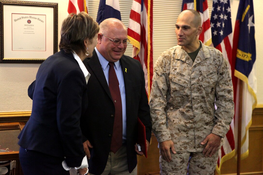 Jesse L. Turner (center) was awarded the Federal Length of Service Award at the installation headquarters aboard Marine Corps Base Camp Lejeune Sept. 12 after serving in the Coast Guard and later working as a safety specialist for recreation and off-duty safety program manager for 30 years. Brig. Gen. Thomas A. Gorry (right), commanding general of Marine Corps Installations East – MCB Camp Lejeune, presented the award to Turner.