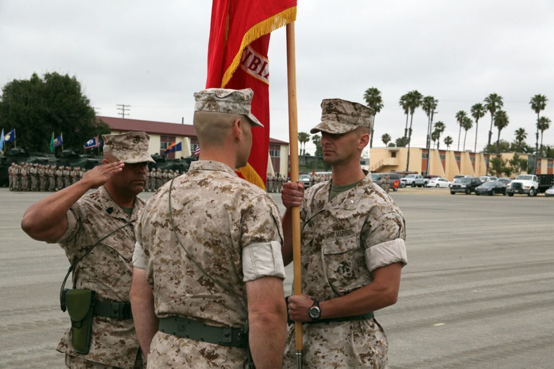 Lt. Col. Daryl G. Crane, the commanding officer of 3rd Assault Amphibian Battalion, 1st Marine Division, presents the battle colors to his replacement Lt. Col. Howard F. Hall during a change of command ceremony at Del Mar, June 16. Sgt. Maj. Alberto Ruiz retrieved the colors from the color guard and presented to the off going battalion commander and took it from the new battalion commander after their exchange. The passing of the battle colors represents the passing of authority from one commander to another.