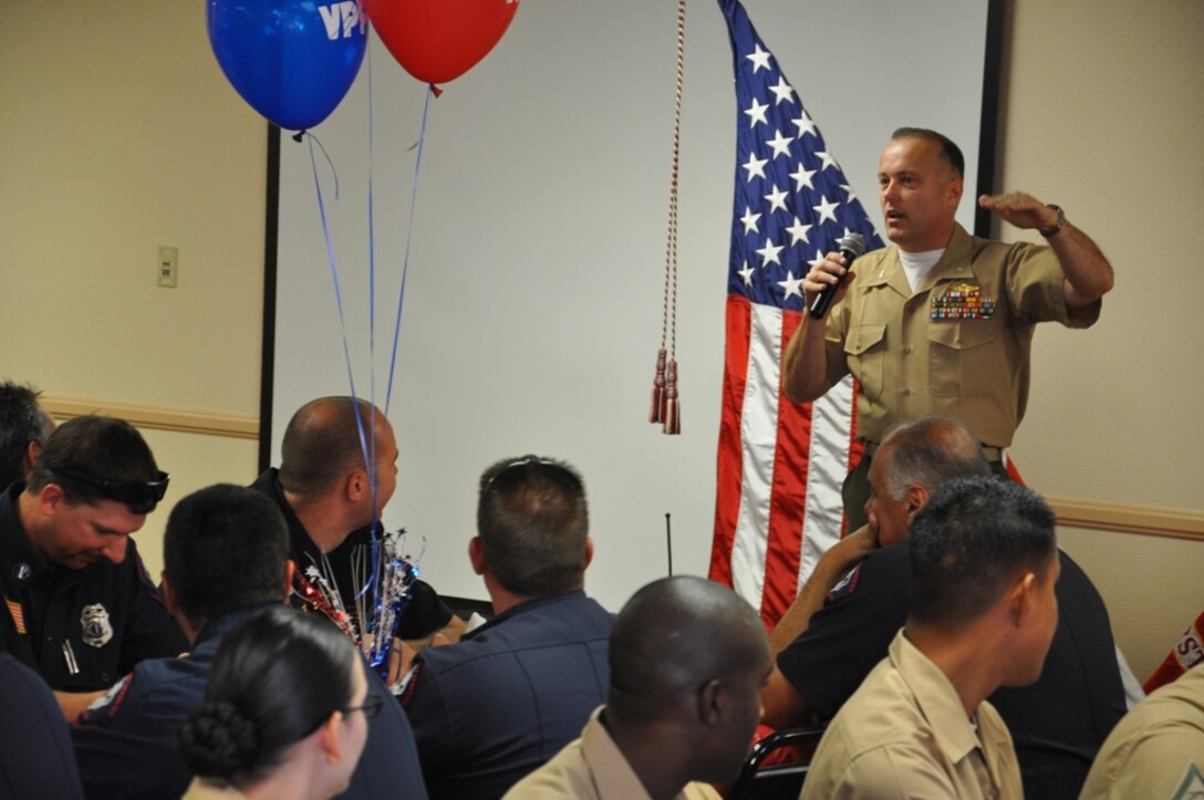 Colonel Michael L. Scalise, commanding officer of Marine Corps Logistics base Barstow, speaks in front of Marines and Civilian Marines during the Voluntary Protection Program’s Lunch and Learn, Aug. 30. Scalise presented three different awards to departments who exceeded the high safety standards throughout the command.  
