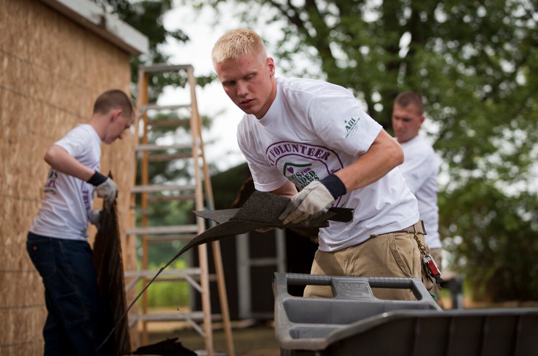 Volunteer Marines for the Homes for Wounded Warriors Program helped remove shingles during a house-building project for wounded Marine Sgt. Jesse James on July 26th, 2012. The reserve Marines, based out of Peru, Ind., joined Habitat for Humanity and the Homes for Wounded Warriors Program to help build James a household prior to his return from military service.
