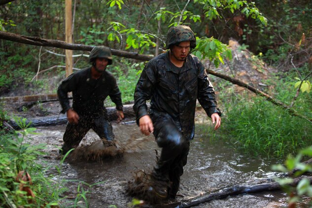 Marines with Landing Support Company, Combat Logistics Regiment 27, 2nd Marine Logistics Group ford the swampy waters running through the endurance course at Battle Skills Training School aboard Camp Lejeune, N.C., Sept. 14, 2012. The troops reached the end of the course as the fatigue, stress and horrible smell of the swamps started to drain their ability to press forward.