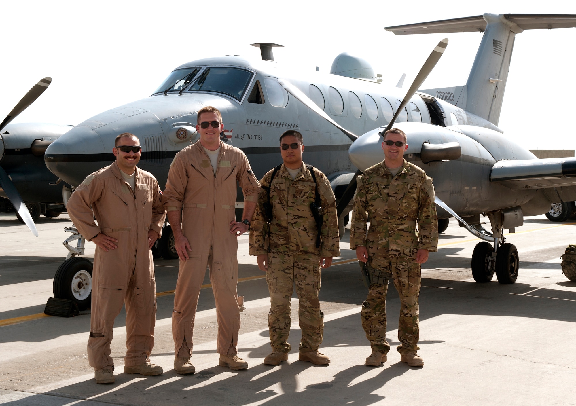 MC-12 Liberty crew members from the 4th Expeditionary Reconnaissance Squadron pause for a photo in front of one of their aircraft at Bagram Airfield, Afghanistan, September 11, 2012. The conclusion of this mission marks a milestone, as it signifies the 4 ERS officially exceeding over 100,000 flying hours using the MC-12s since the unit was stood up in Dec. 2009. 100,000 flying hours roughly equates to 11 and a-half years of flying for one the aircraft. 4 ERS leadership can say they accomplished this feat in under three years using its fleet of MC-12s. (U.S. Air Force photo/1st Lt. Marlene Solano)