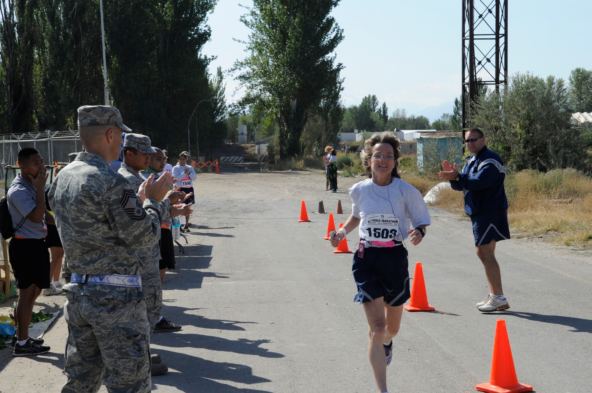 Chief Master Sgt. Lisa Jayne races towards the finish line during the U.S. Air Force Marathon at the Transit Center at Manas, Kyrgyzsatan, Sept. 15, 2012. Jayne serves as the 376th Expeditionary Medical Group chief enlisted manager and is deployed from Wright-Patterson Air Force Base, Ohio. The marathon originates at Wright-Patterson and takes place every year in September to coincide with the establishment of the U.S. Air Force as an independent service 65 years ago. (U.S. Air Force photo/Master Sgt. Jason Vaught) 

