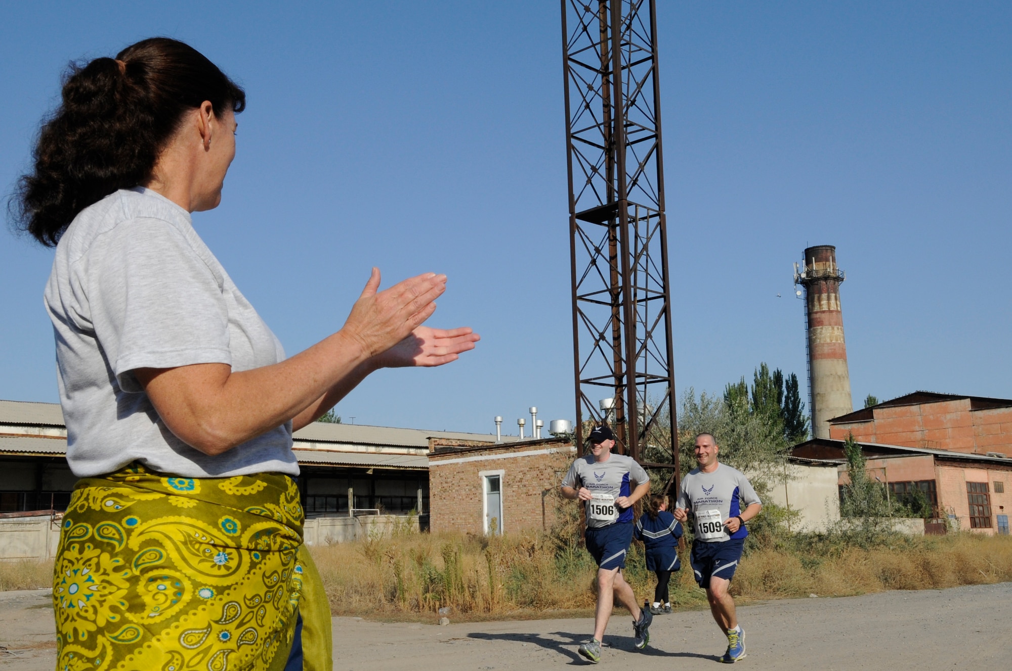 Staff Sgt. David Woolery and Master Sgt. Michael Remy sprint through the halfway mark during the U.S. Air Force Marathon at the Transit Center at Manas, Kyrgyzsatan, Sept. 15, 2012. Over 150 participants took part in one of three categories; 10K, half marathon and a 26.2 mile marathon.  Woolery is a 376th Expeditionary Medical Group information systems technician and Remy is a public health technician. The two participants are deployed from Wright-Patterson Air Force Base, Ohio. (U.S. Air Force photo/Master Sgt. Jason Vaught) 