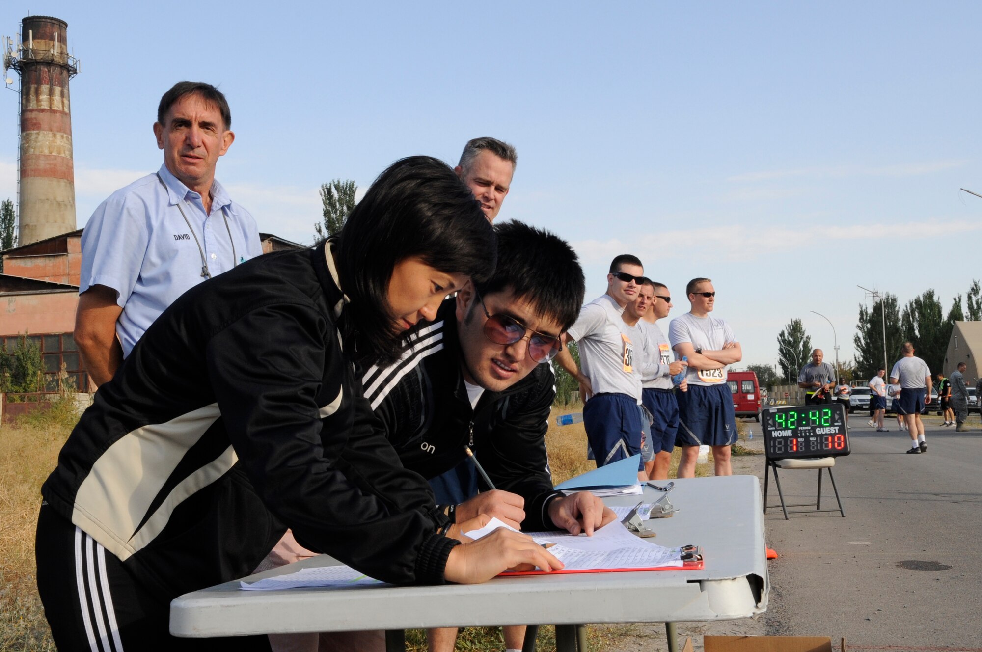 Dinara Tologonova and Mirlan Makeev record the times of runners as they finish the U.S. Air Force Marathon at the Transit Center at Manas, Kyrgyzsatan, Sept. 15, 2012. Over 150 runners took part in one of three categories; 10K, half marathon and a 26.2 mile full marathon.  Tologonova and Makeev are 376th Expeditionary Force Support Squadron fitness center supervisors who manage fitness activities for the deployed men and women of the Transit Center. (U.S. Air Force photo/Master Sgt. Jason Vaught)