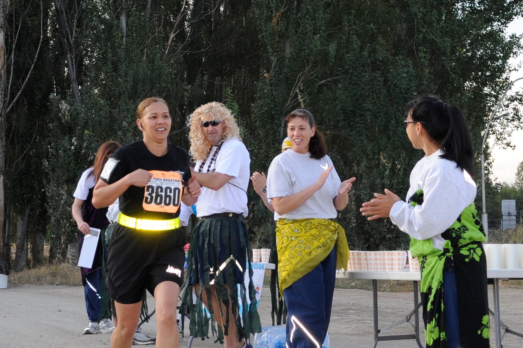 Sergeant First Class Faye Dora Sanchez runs past the last water station prior to finishing a 10K during the U.S. Air Force Marathon at the Transit Center at Manas, Kyrgyzsatan, Sept. 15, 2012. Over 150 runners took part in one of three categories; 10K, half marathon and a 26.2 mile full marathon. Sanchez is a 379th Customs Processing Office customs agent and is deployed from the Army National Guard, Guam. (U.S. Air Force photo/Master Sgt. Jason Vaught) 