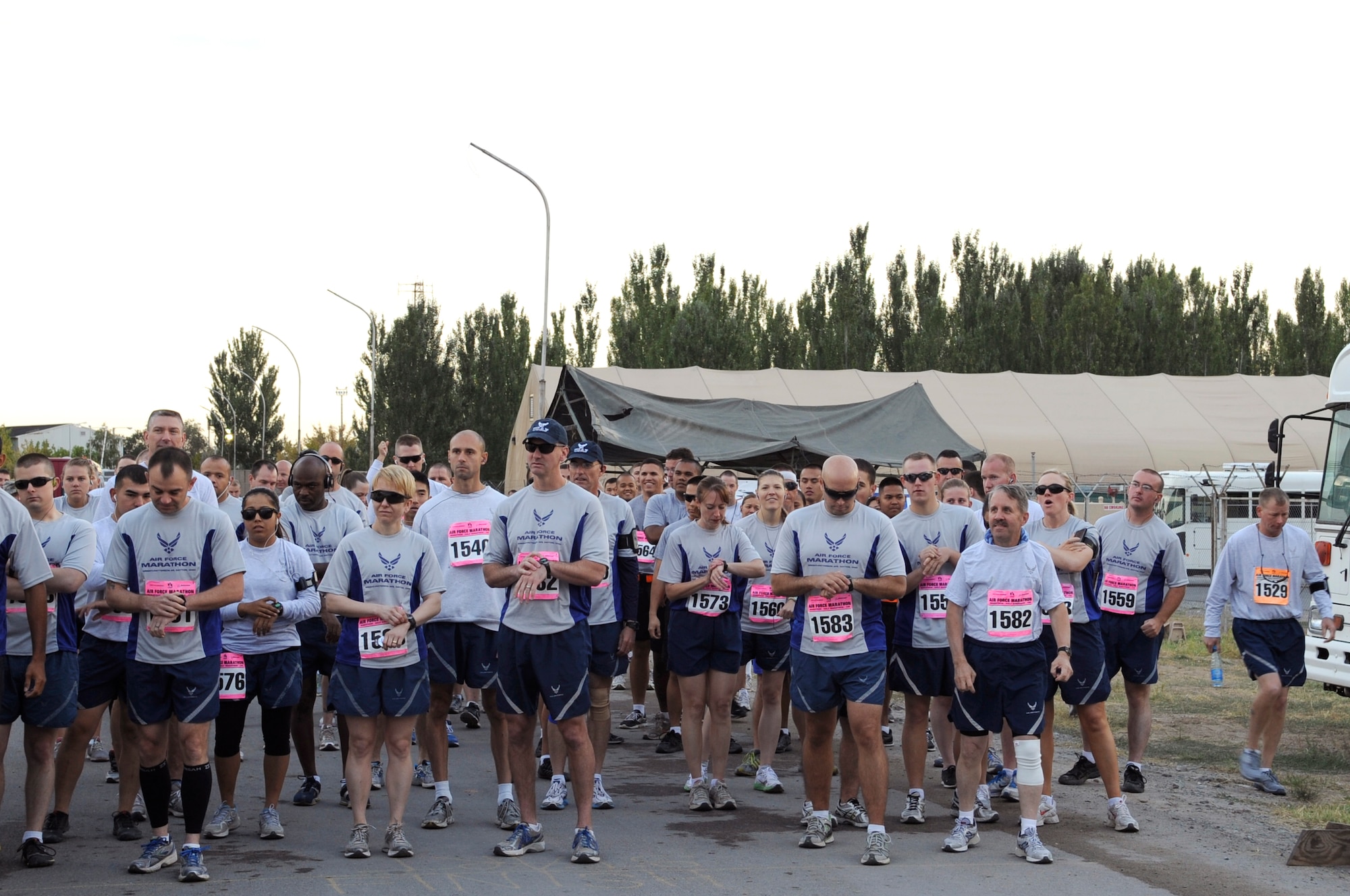 Participants of the half marathon set their watches prior to taking part in the U.S. Air Force Marathon at the Transit Center at Manas, Kyrgyzstan, Sept. 15, 2012. Deployed locations like the Transit Center are known for hosting the Air Force Marathon to help build morale and promoting fitness among participants. The marathon originates at Wright-Patterson Air Force Base, Ohio and takes place every year in September to coincide with the establishment of the U.S. Air Force as an independent service 65 years ago. (U.S. Air Force photo/Master Sgt. Jason Vaught)