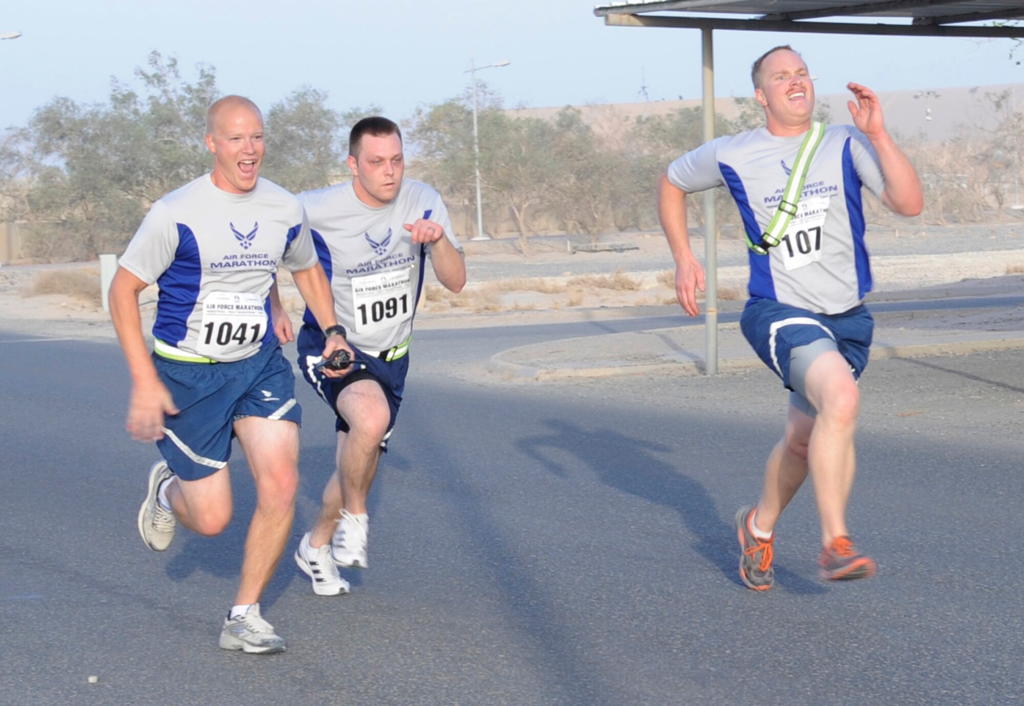 SOUTHWEST ASIA – Members of the 386th Air Expeditionary Wing sprint to the finish line during the Air Force Marathon here Sept. 15. This is the 6th year the Air Force has sanctioned deployed location races overseas. These races offer the military a chance to share the experience and camaraderie associated with this world-class event. (U.S. Air Force photo/Staff Sgt. Alexandra M. Boutte)