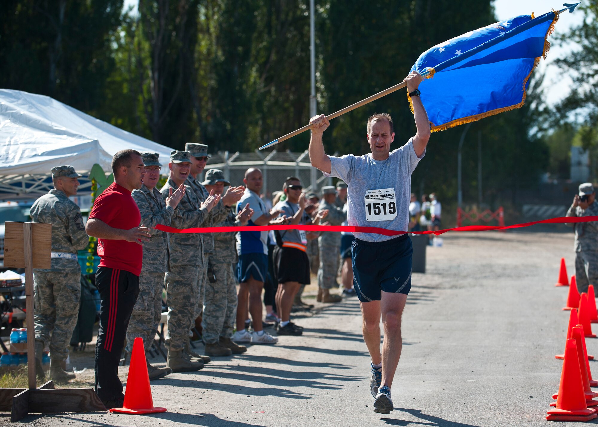 Col. Corey Martin crosses the finish line after running the Air Force Marathon at the Transit Center at Manas, Kyrgyzstan, Sept. 15, 2012. Martin finished first in the full marathon with a time of 3:28:08. He is the 376th Air Expeditionary Wing commander. (U.S. Air Force photo/Senior Airman Brett Clashman)