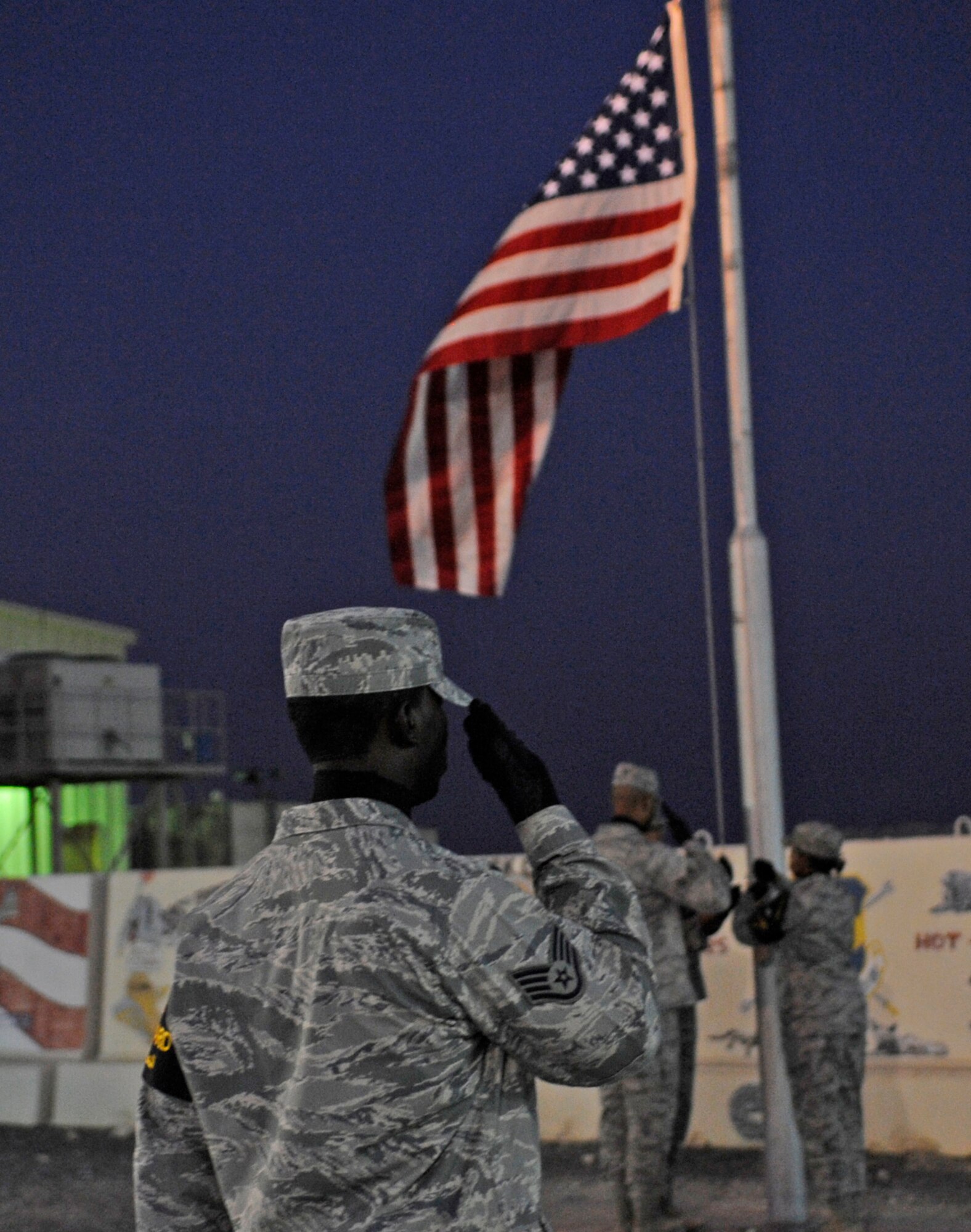 SOUTHWEST ASIA – Members of the 386th Air Expeditionary Wing Honor Guard lower the American Flag during a retreat ceremony after the 9/11 Memorial Ceremony Sept. 11.  (U.S. Air Force photo/Staff Sgt. Alexandra M. Boutte)
