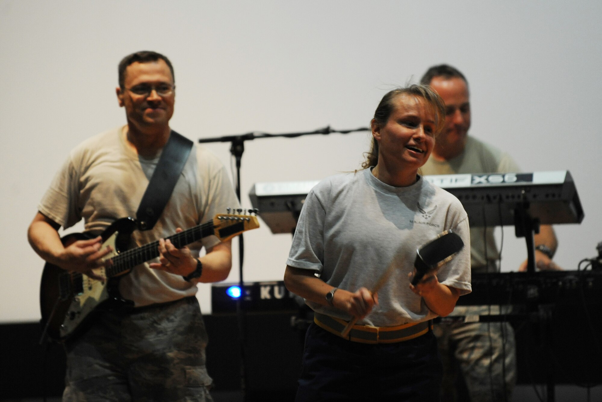 SOUTHWEST ASIA – Col. Amy Stryker, 386th Air Expeditionary Wing director of staff, plays the cowbell during a performance with the U.S. Air Forces Central Band Top Flight at the Rock Theater Sept. 8. (U.S. Air Force photo/Staff Sgt. Alexandra M. Boutte)