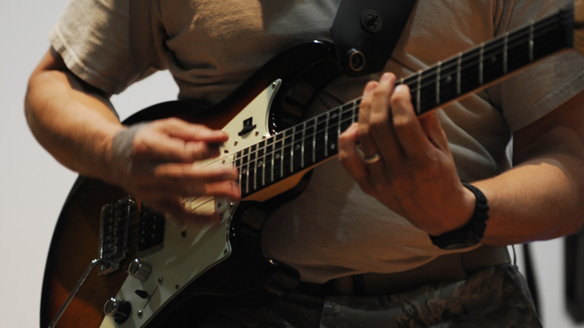 SOUTHWEST ASIA – Staff Sgt. Greg Lacy, U.S. Air Forces Central Band guitarist, strums his guitar during a solo, performing for the 386th Air Expeditionary Wing Airmen at the Rock Theater Sept. 8.  The AFCENT Band is the first permanently assigned Air Force Band to the Central Command area of responsibility. Based in Southwest Asia, the band is comprised of deployed Airmen from active duty, Reserve and Air National Guard bands. (U.S. Air Force photo/Staff Sgt. Alexandra M. Boutte)
