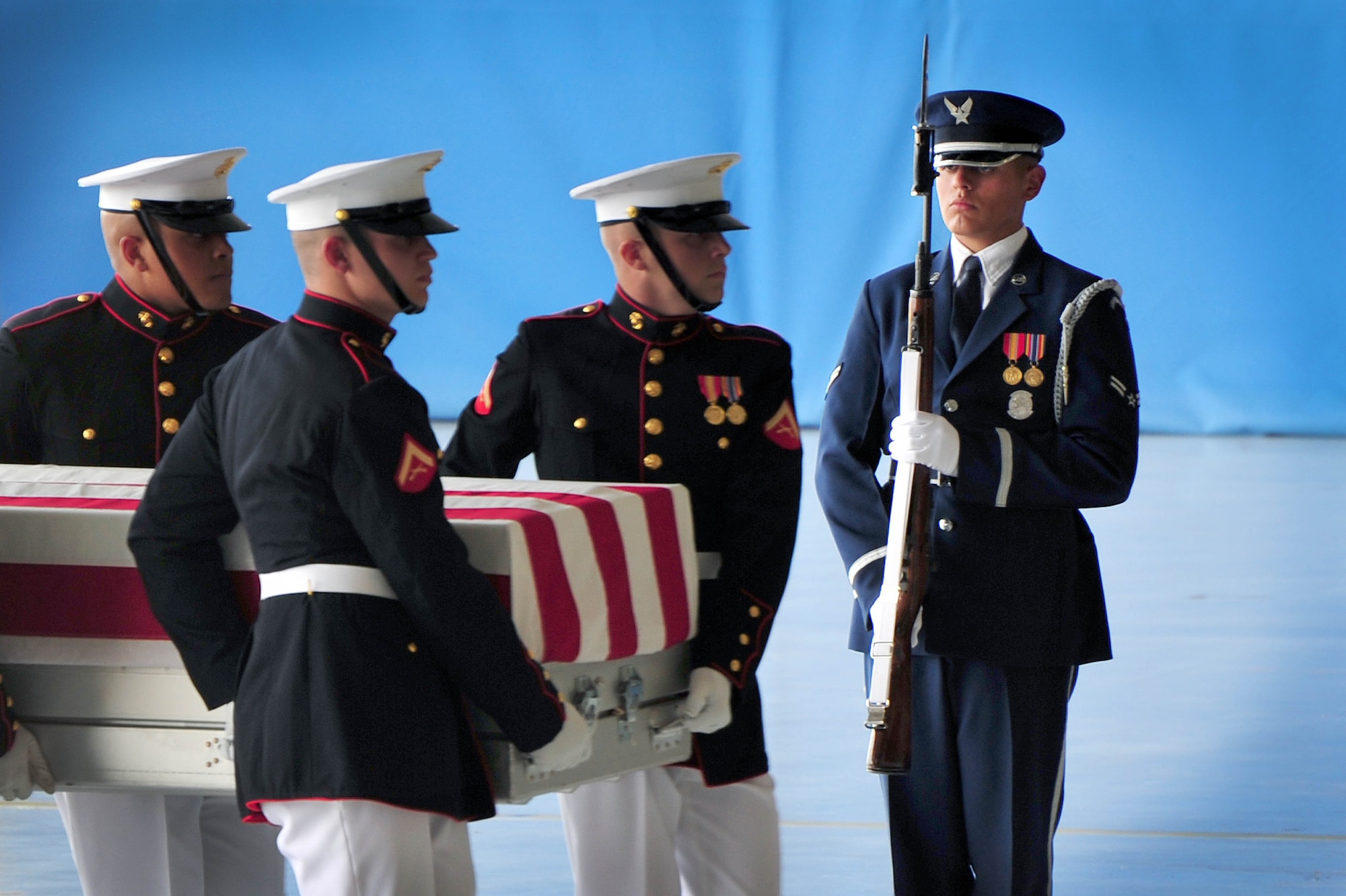 The United States Air Force Honor Guard ceremonial guardsman presents arms during a dignified transfer ceremony Sept. 14 at Joint Base Andrews, Md. Ceremonial guard members from all branches of the Department of Defense worked jointly to honor U.S. Foreign Service members killed during attacks to the U.S. consulate Sept. 11, 2012, in Benghazi, Libya. (U.S. Air Force photo by Senior Airman Steele C. G. Britton)