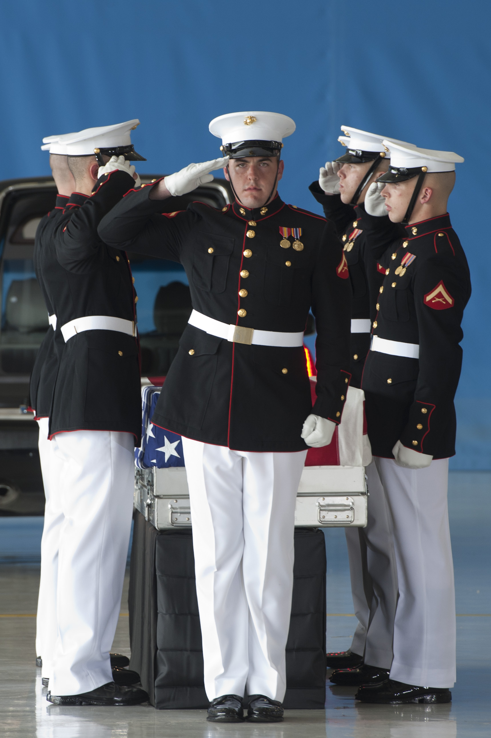 U.S. Marines salute during the dignified transfer ceremony for the U.S ...