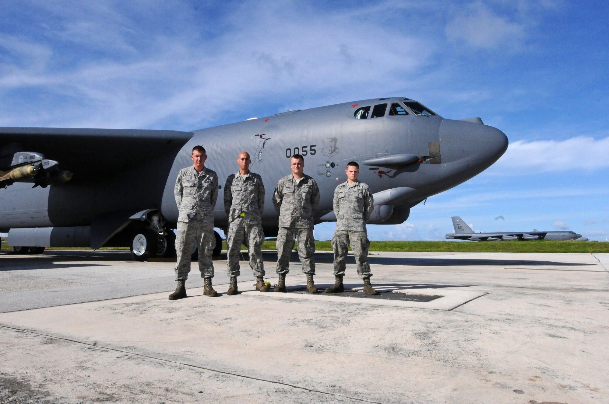 ANDERSEN AIR FORCE BASE, Guam  -- "Nine-O-Nine" award winners Airman 1st Class Daniel Greig, Staff Sgt. Timothy Knighting, Staff Sgt. Jason Hanna, Senior Airman Mathew Phinney, 36th Expeditionary Aircraft Maintenance Squadron crew chiefs, stand in front of B-52 Stratofortress A0055 on the flightline here, July 24. Under the aircrew’s care, B-52 A1040 accomplished 20 consecutive sorties without a maintenance abort. (U.S. Air Force photo by Senior Airman Carlin Leslie/Released)