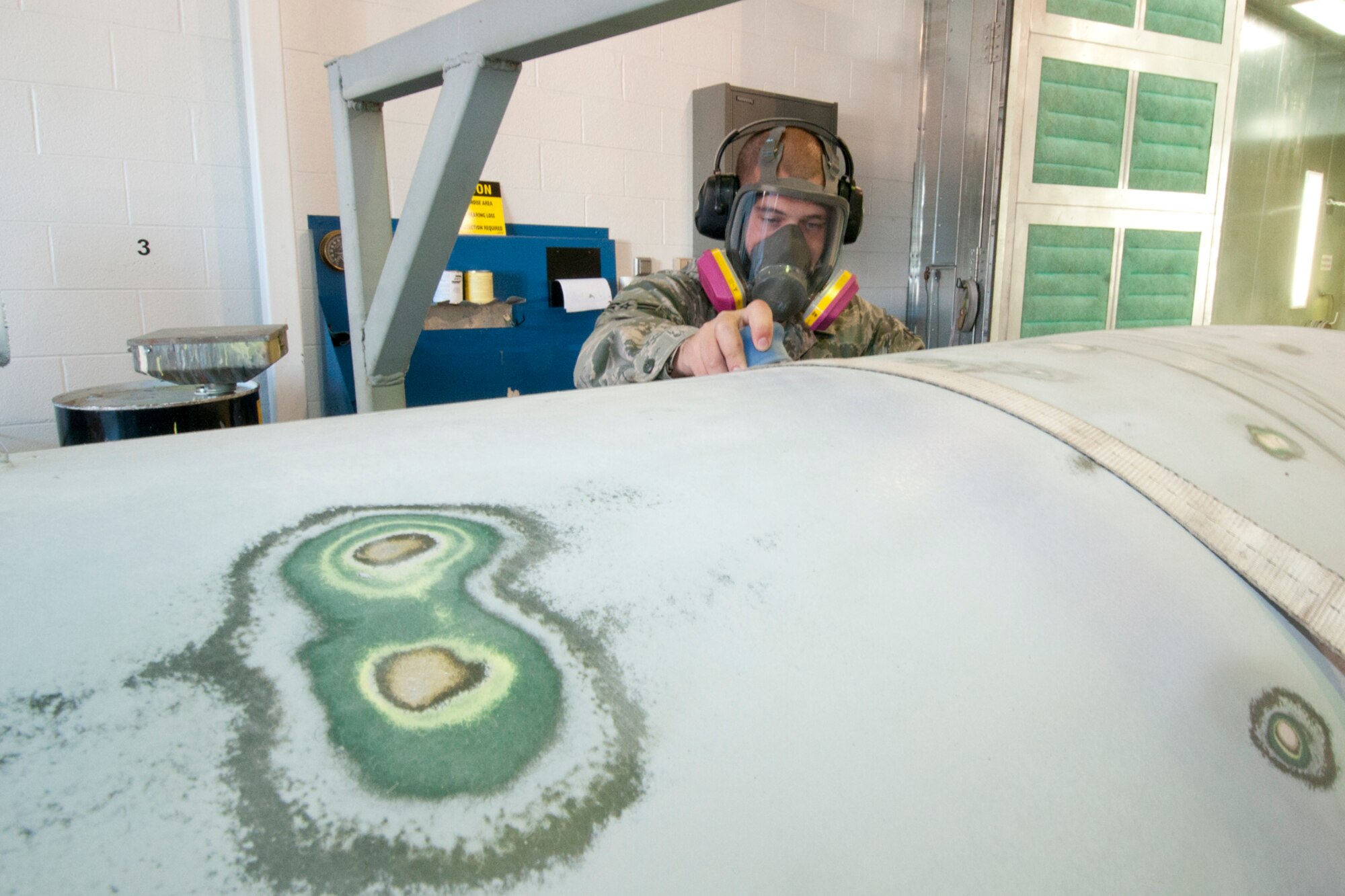 120915-Z-NJ721-014: Airman 1st Class Dan Butcher uses a sander to prepare a centerline tank for a fresh coat of paint, while working in the painting bay of the 127th Maintenance Squadron at Selfridge Air National Guard Base, Mich., Sept. 15, 2012. The sander has a vacuum attachment to control dust. While maintenance Airmen at the base said the paint on an aircraft plays a major role in corrosion control and has other benefits, they also take a great deal of pride in the appearance of the aircraft they maintain.  The centerline tank is used by A-10 Thunderbolt II aircraft assigned to the base as an additional, external fuel tank when the aircraft must make long treks, such as a trip overseas. (Air National Guard photo by TSgt. Robert Hanet)