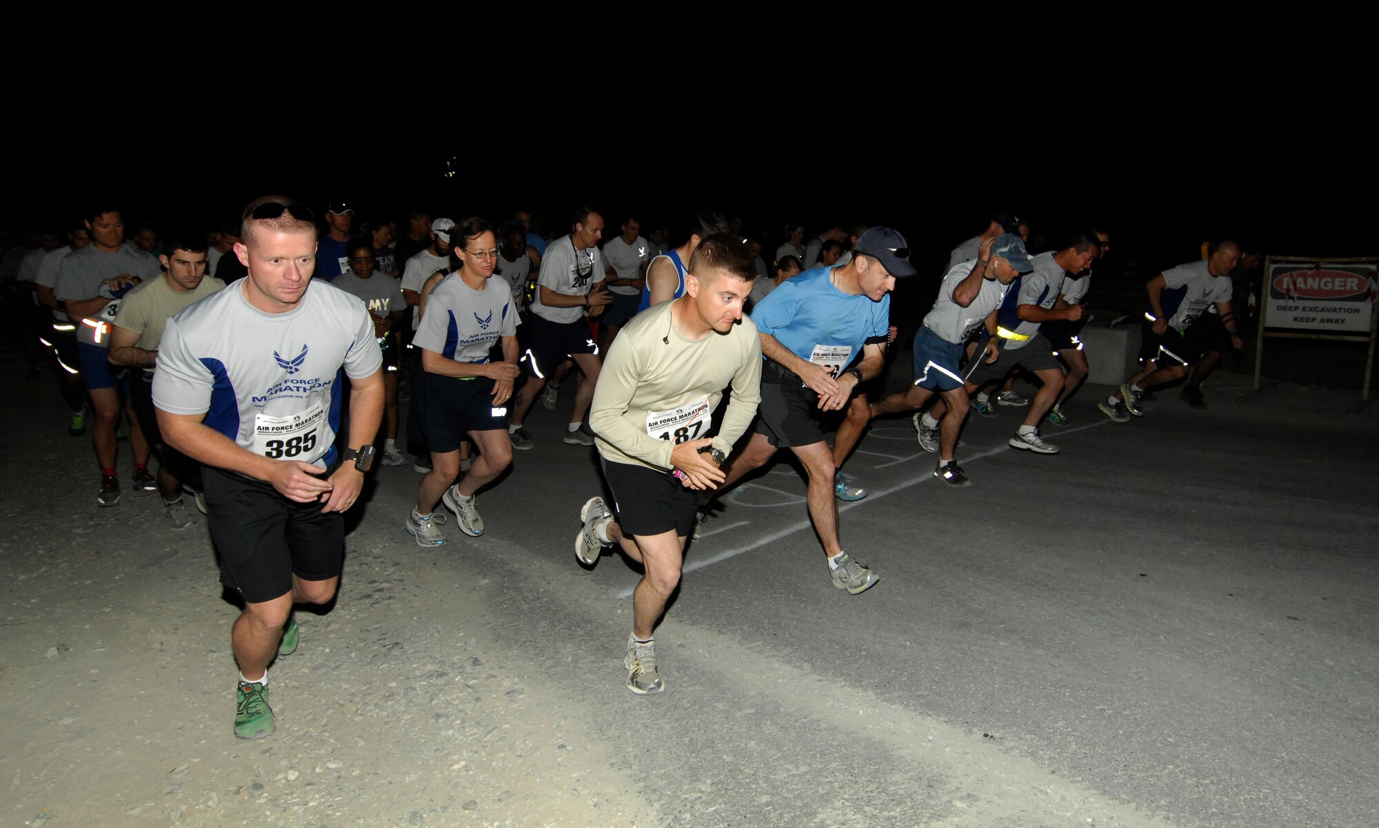 Personnel at Bagram Airfield, Afghanistan, begin running at the start of the U.S. Air Force Marathon (Bagram) Sept. 15, 2012. More than 500 people registered to run. Runners chose from four distances; the full-marathon, the half-marathon, a ten-kilometer run, or a five-kilometer run. Bagram was one of seven deployed locations throughout the area of responsibility that participated in the Marathon. (U.S. Air Force photo/SSgt Jeff Nevison)