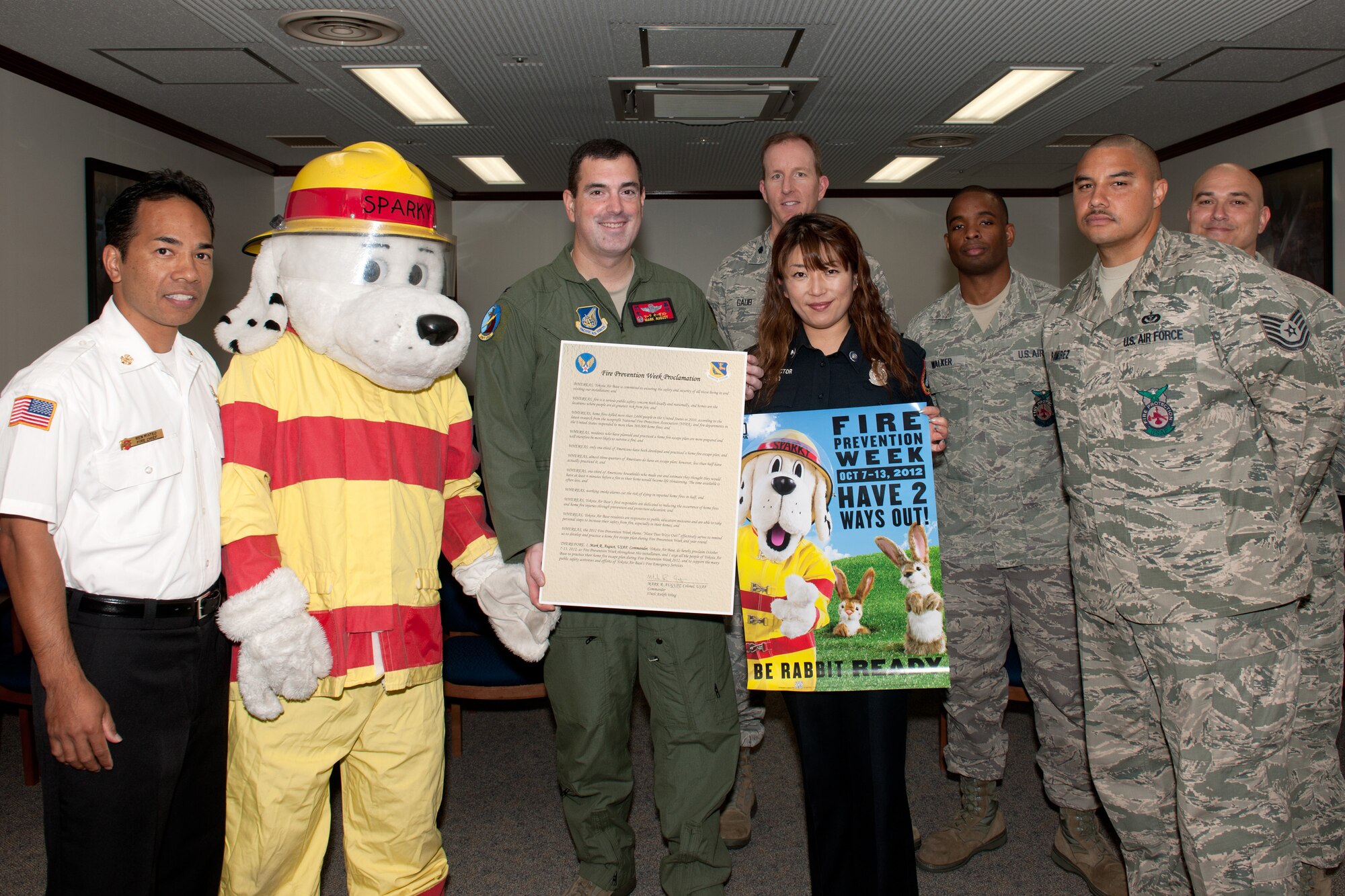 YOKOTA AIR BASE, Japan -- Col. Mark August, center, 374th Airlift Wing commander, and members from the 374th Civil Engineer Squadron Fire Department pose for photo Sept. 14, 2012, at Yokota Air Base, Japan. According to the National Fire Protection Association, U.S. fire departments responded to an estimated 1,389,500 fires in 2011. There was an average of one civilian fire death every 208 minutes and a civilian fire injury every 30 minutes. (U.S. Air Force photo by Osakabe Yasuo)