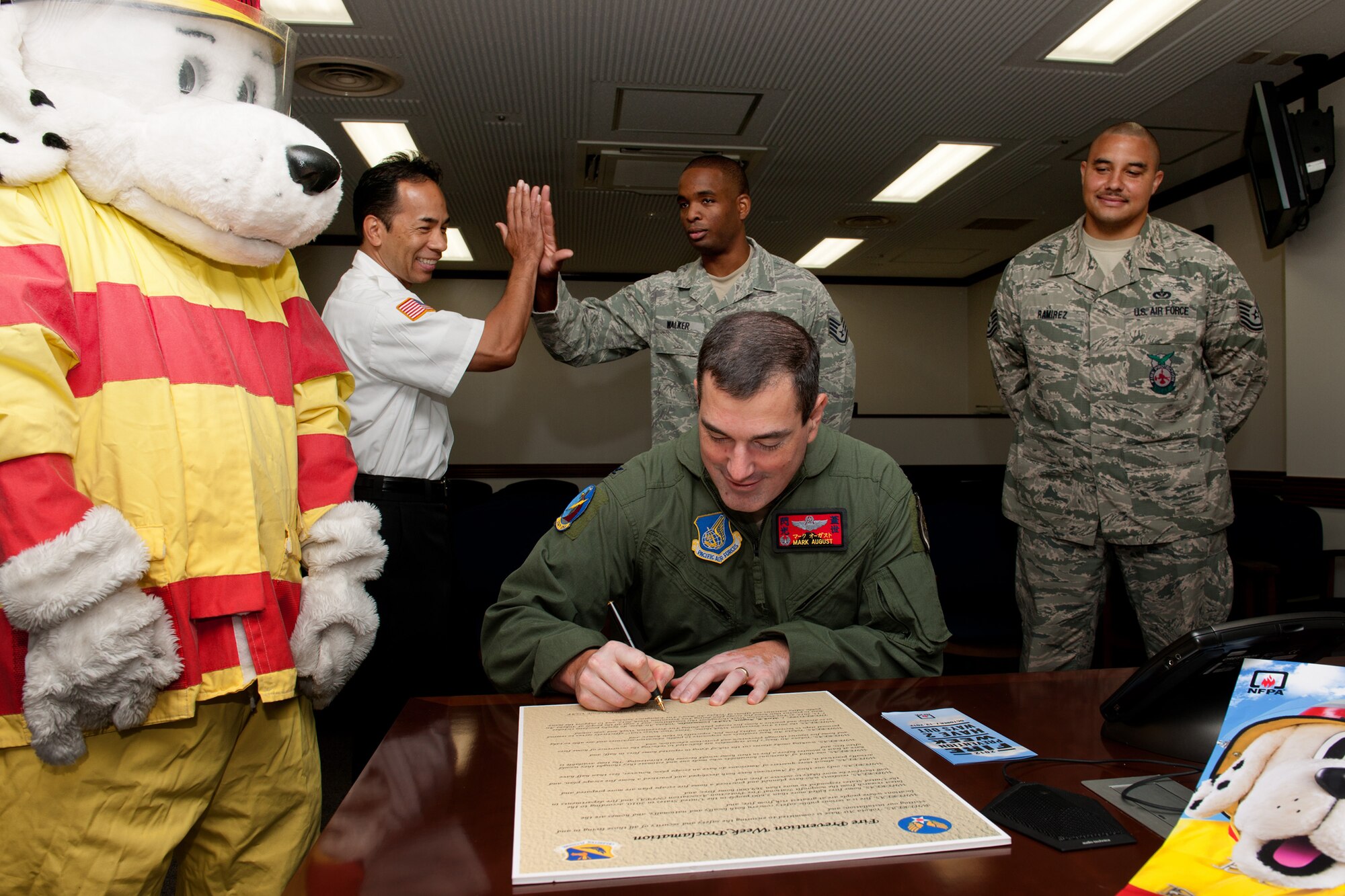 YOKOTA AIR BASE, Japan -- Col. Mark August, 374th Airlift Wing commander, signs a proclamation initiating Fire Prevention Week at Yokota Air Base, Japan, Sept. 14, 2012. According to the National Fire Protection Association, in 2011, U.S. fire departments responded to an estimated 1,389,500 fires, an increase of 4.4 percent from the year before. (U.S. Air Force photo by Osakabe Yasuo)