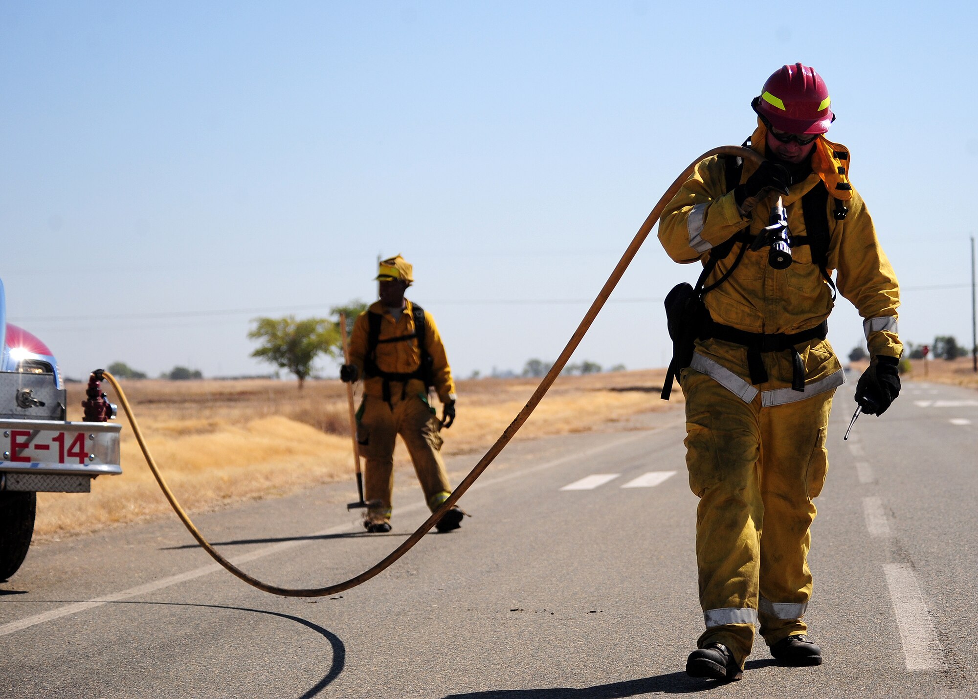 U.S. Air Force firefighters return from combating a grass fire at Beale Air Force Base, Calif., Sept. 13, 2012. More than 14 firefighters and 7 vehicles responded to the blaze. (U.S. Air Force photo by Senior Airman Shawn Nickel/Released)