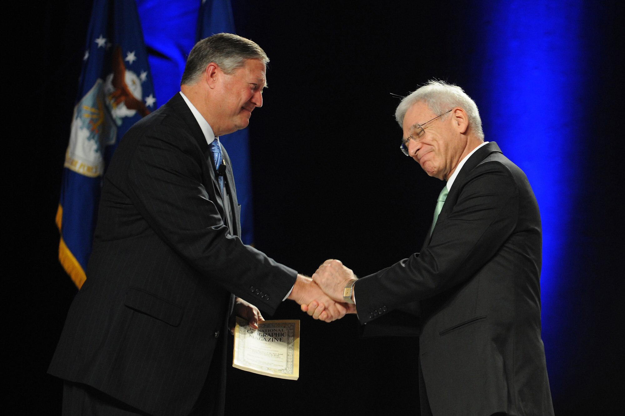 Secretary of the Air Force Michael Donley receives the March 1926 National Geographic Magazine following his address during the Annual Air Force Association's Air and Space Conference and Technology Exposition in Washington, D.C., on September 12, 2012.
